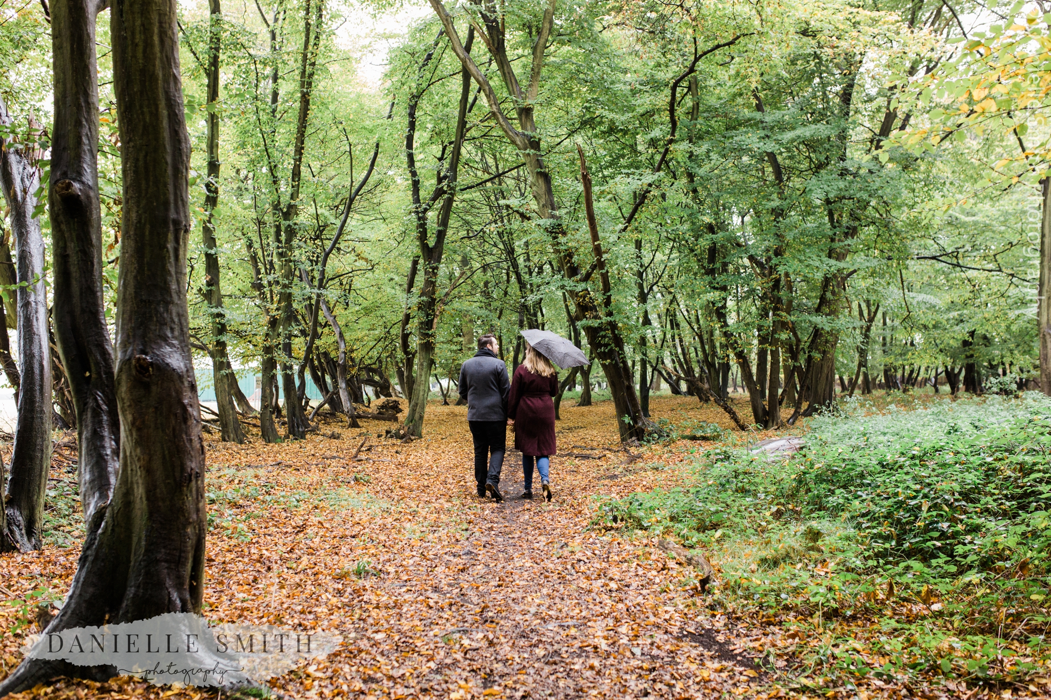 couple walking away in woods