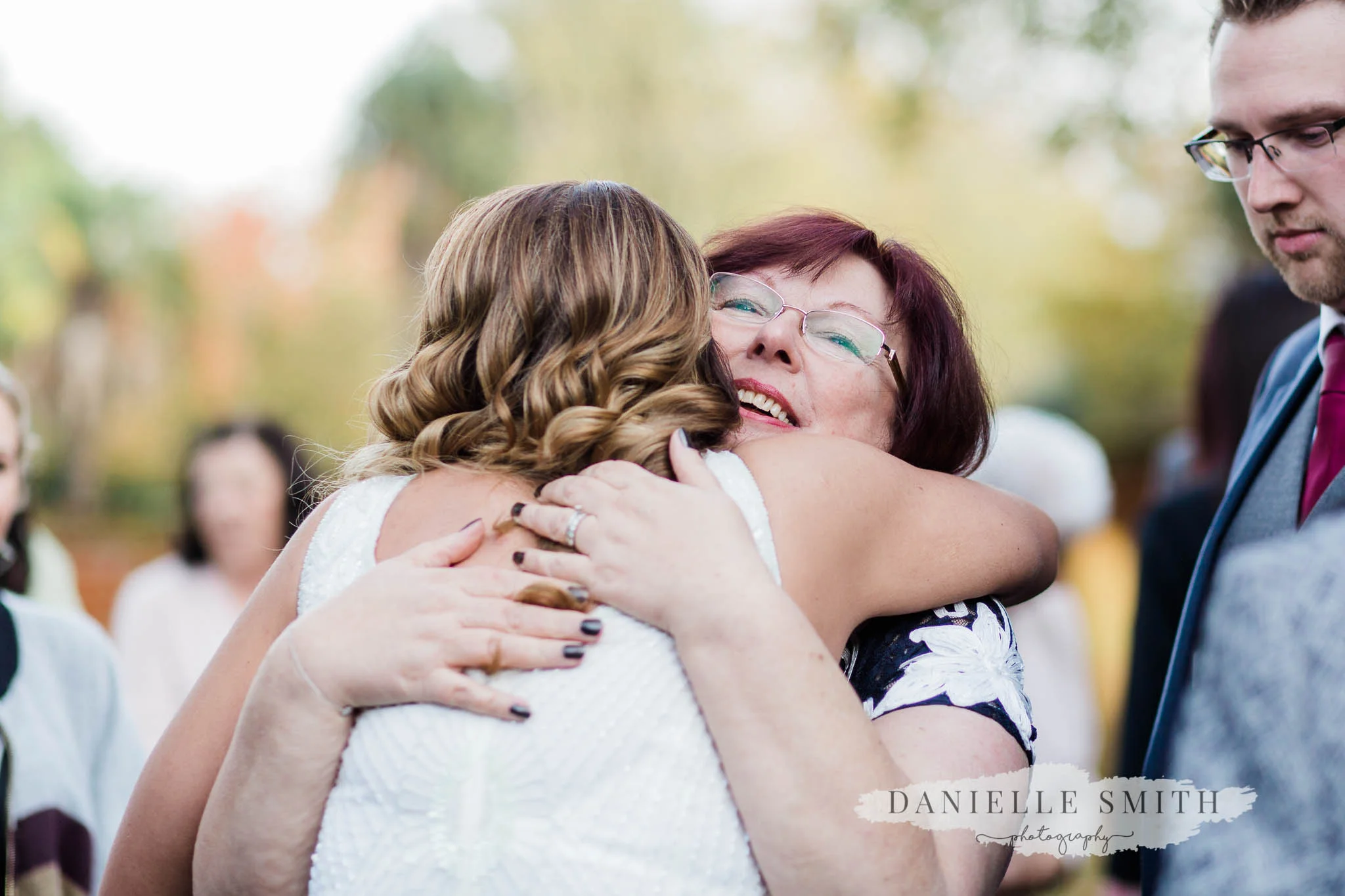 mother of groom hugging bride