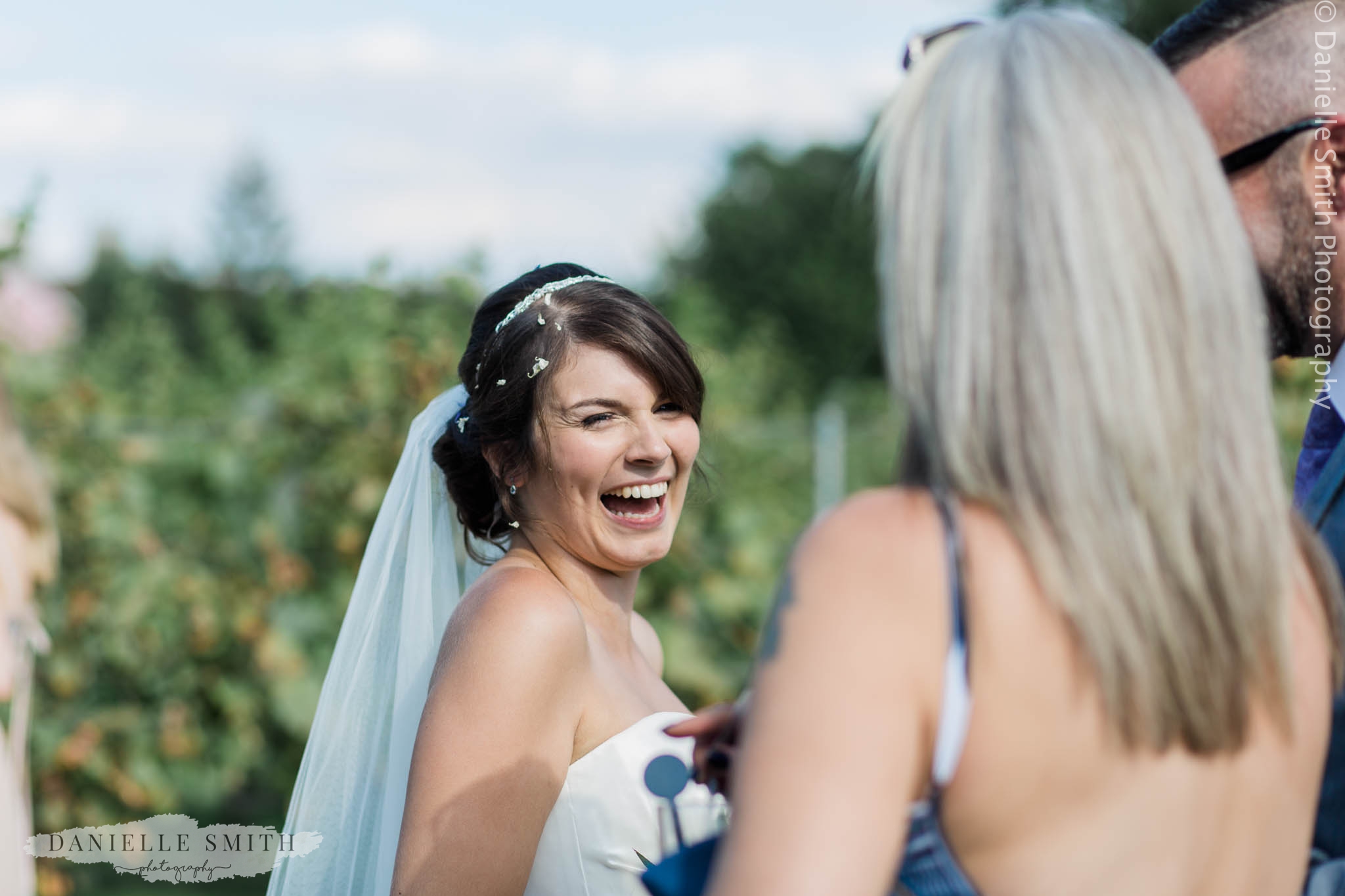 bride laughing at outdoor wedding