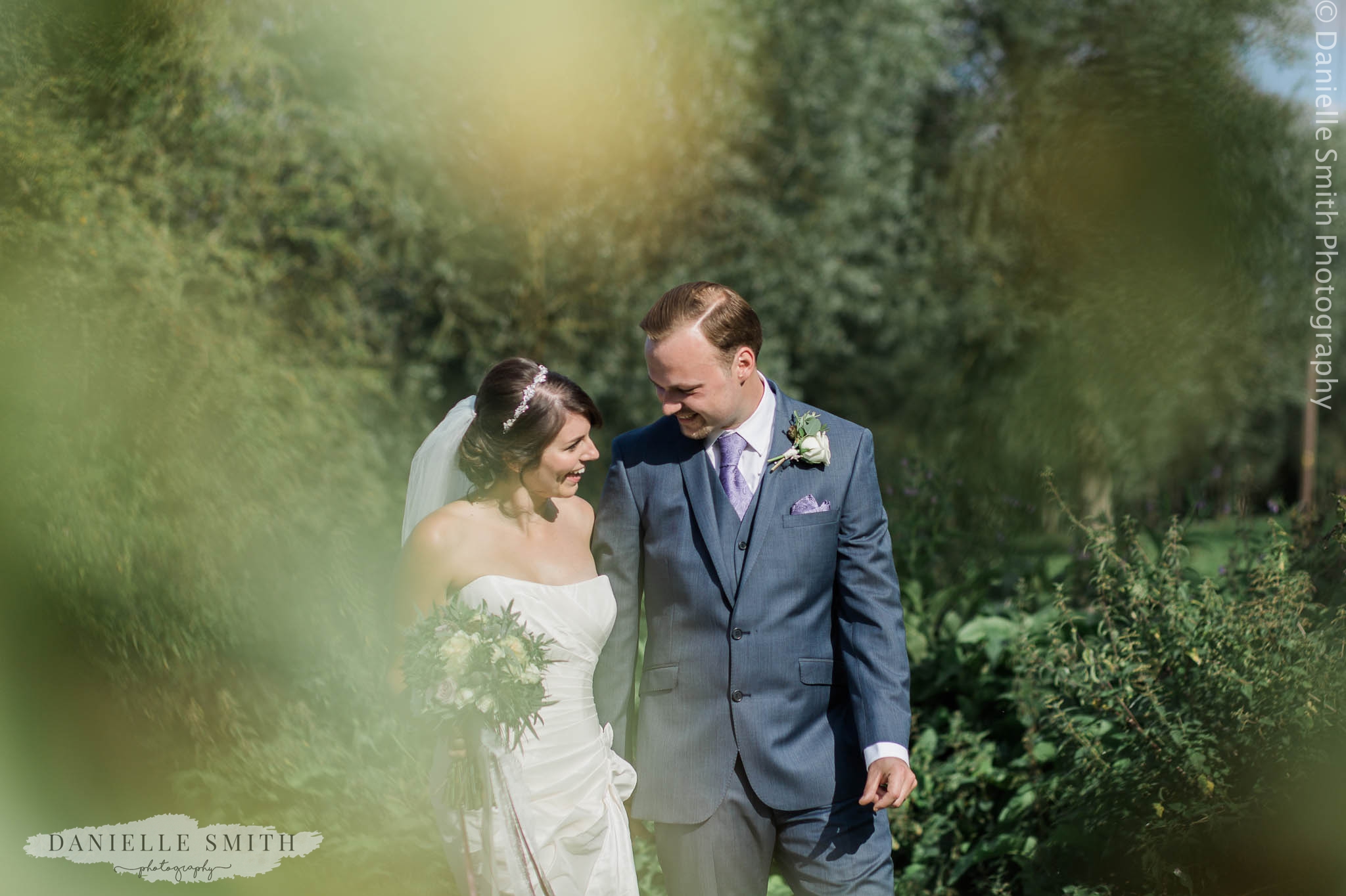 bride and groom smiling at outdoor wedding