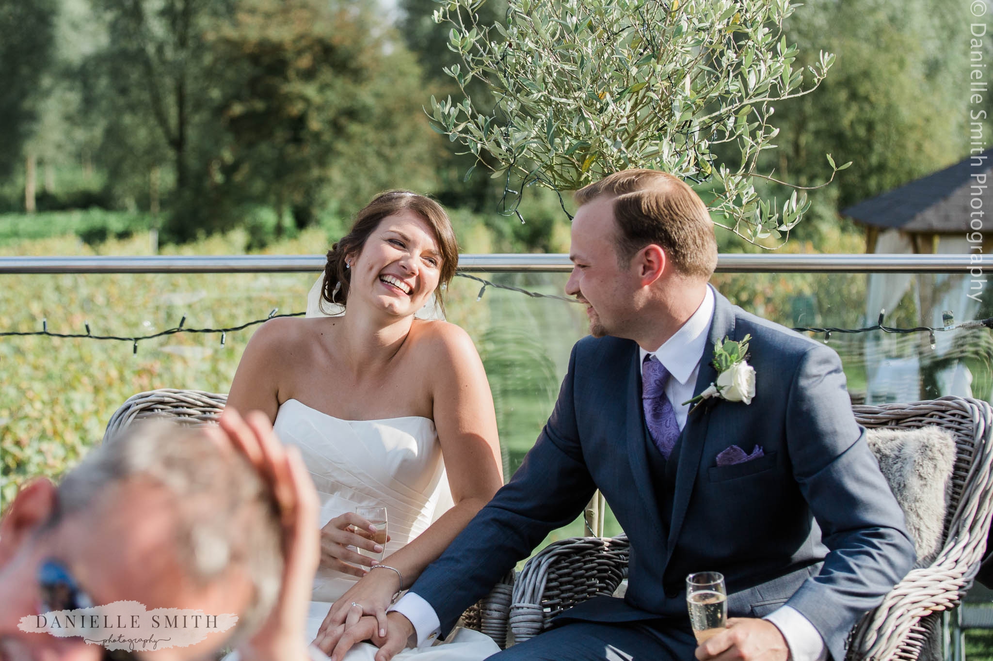 bride and groom laughing at speeches - essex wedding photography