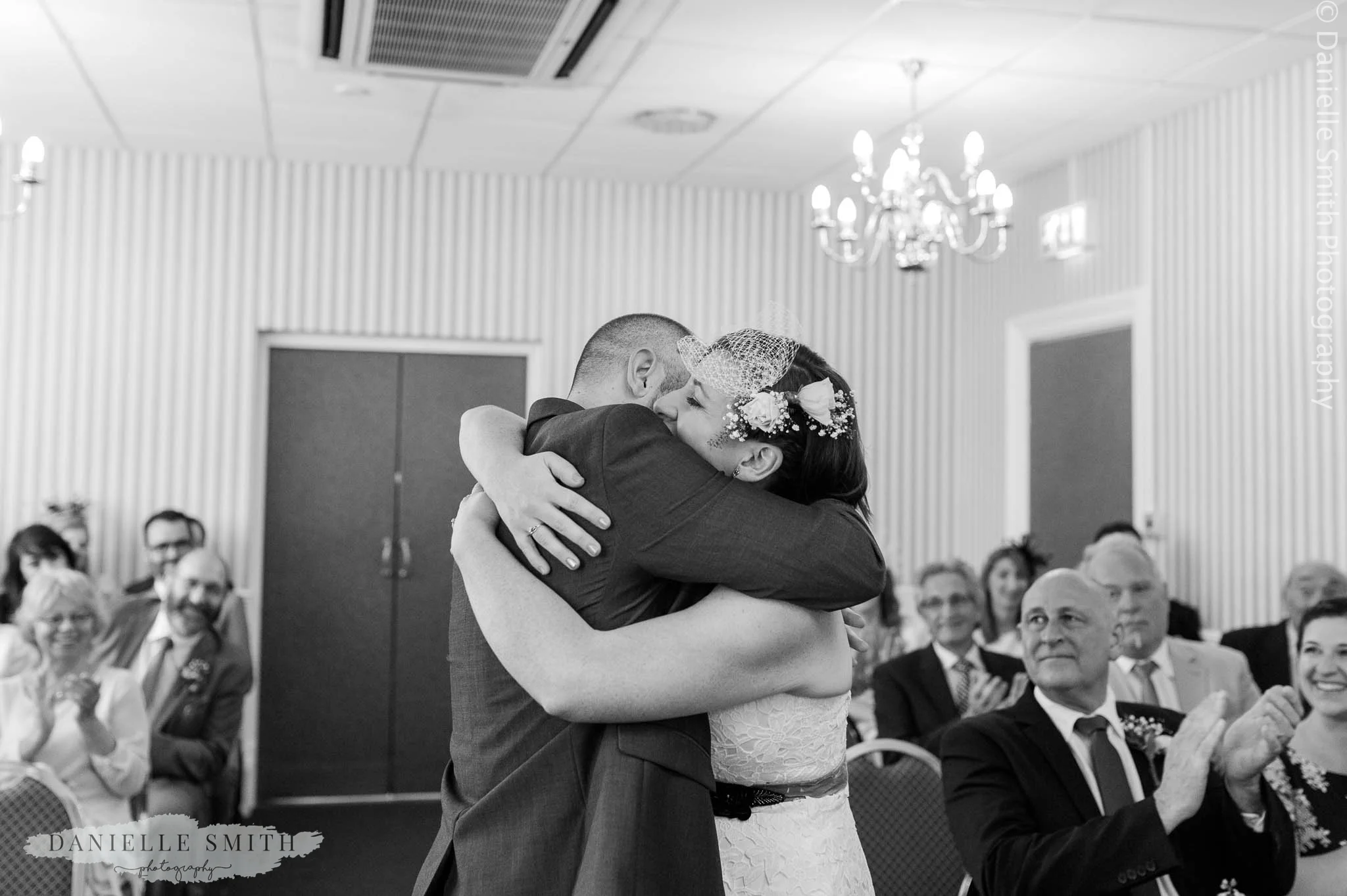 bride and groom hugging