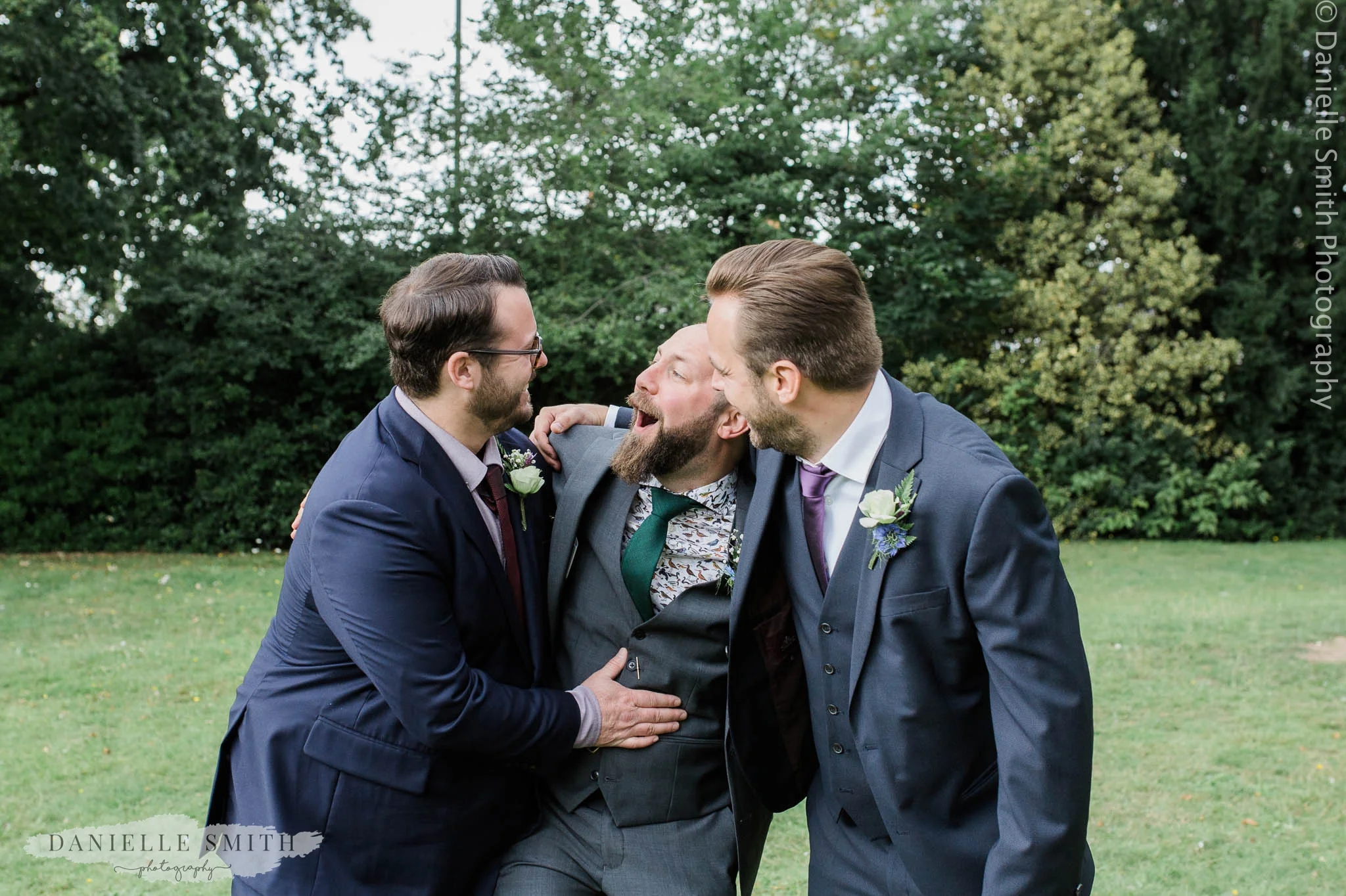 groom being silly with 2 best men