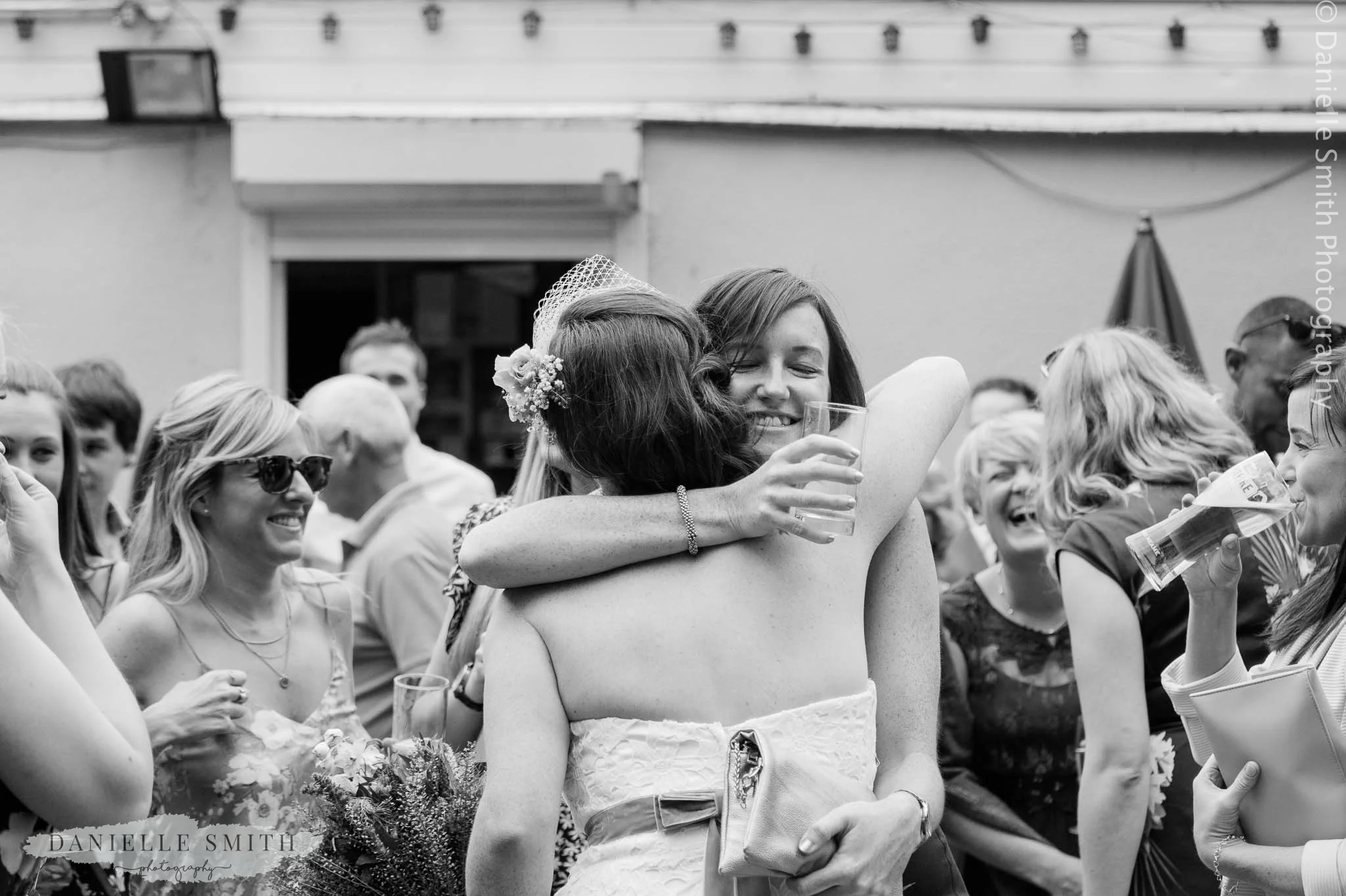 bride hugging her friend - bowls club wedding