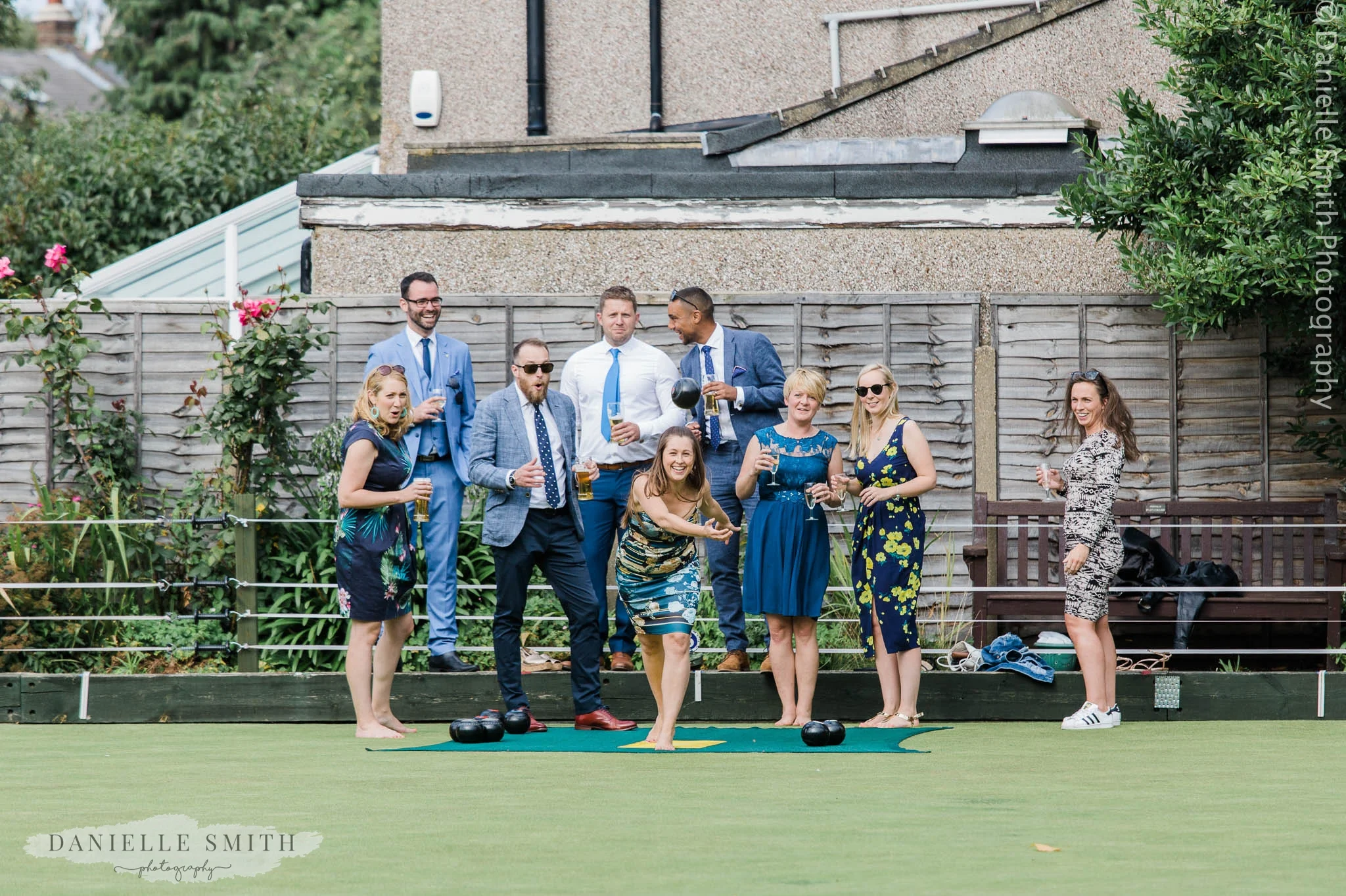 girl throwing bowls ball in air - bowls club wedding