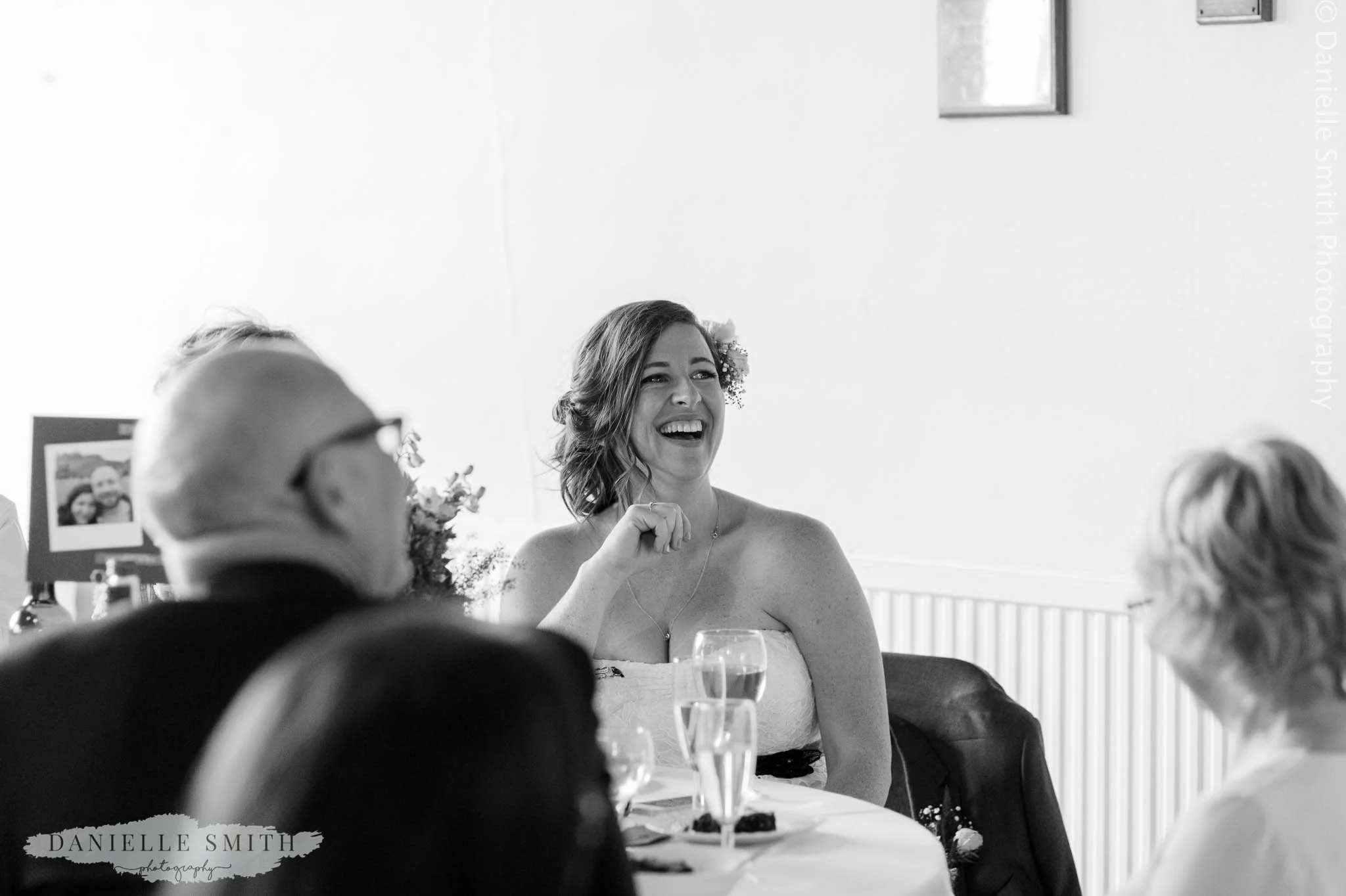 bride laughing during speeches