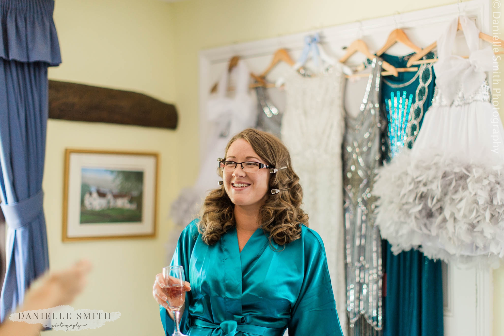 bridesmaid in teal gown laughing