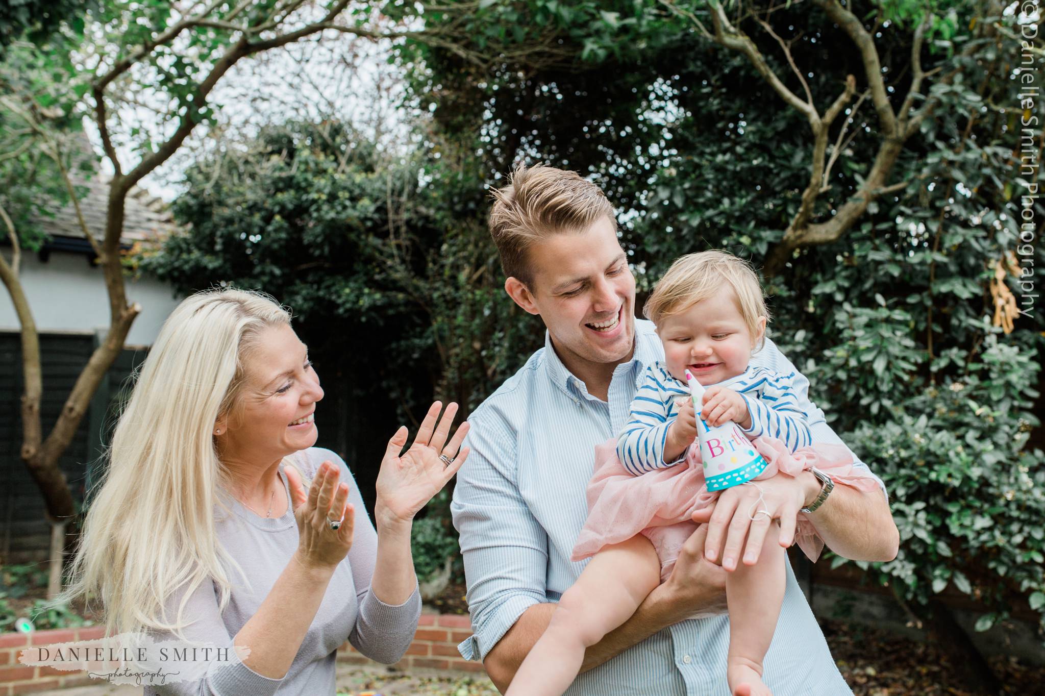 mum and dad with daughter on first birthday