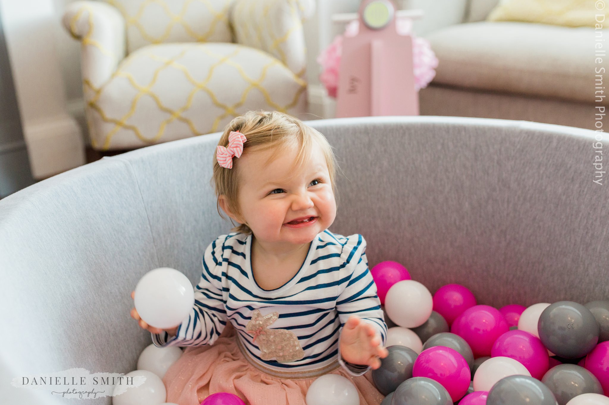 baby girl playing in her ball pool