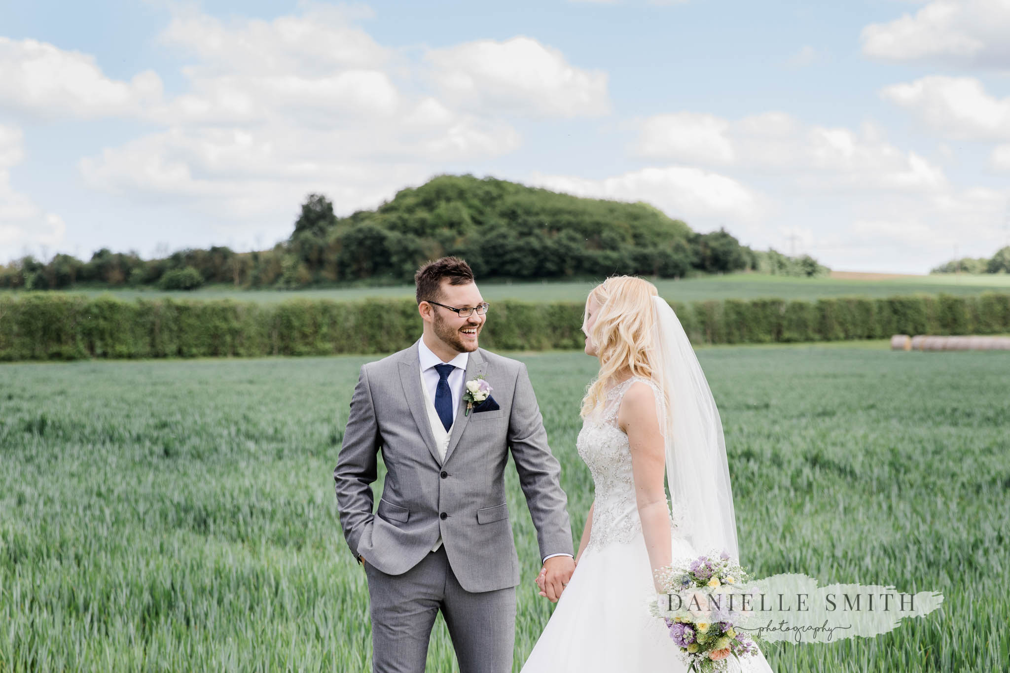 bride and groom in field at cooling castle- wedding photographer kent