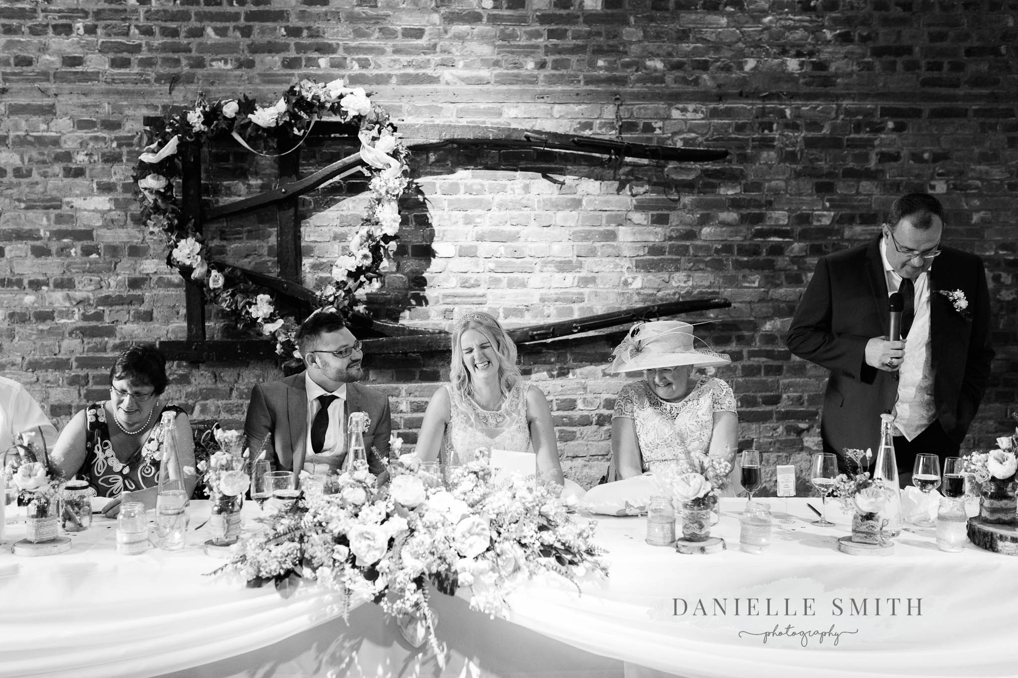 top table laughing during wedding speeches