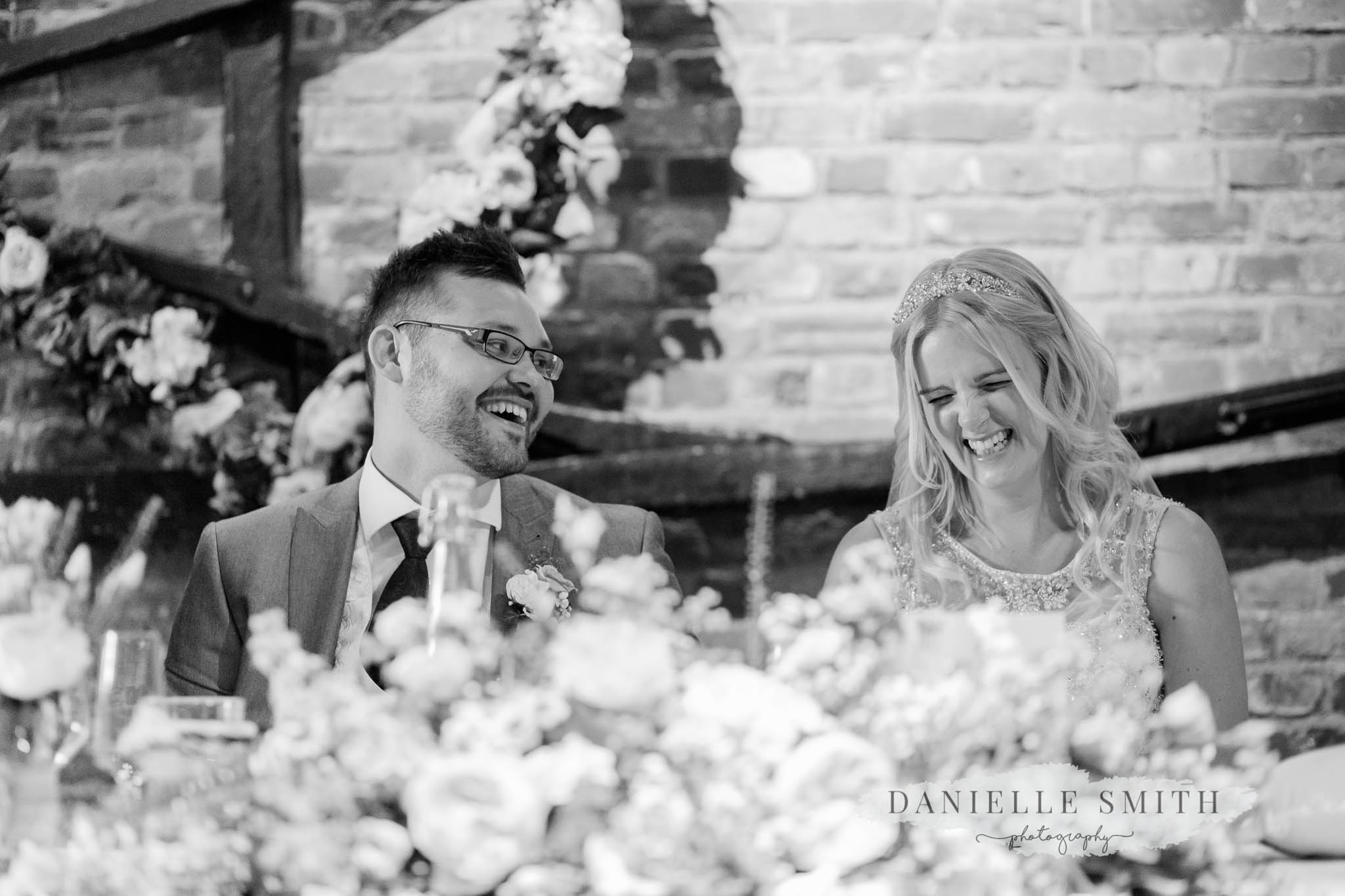 bride and groom laughing during speeches