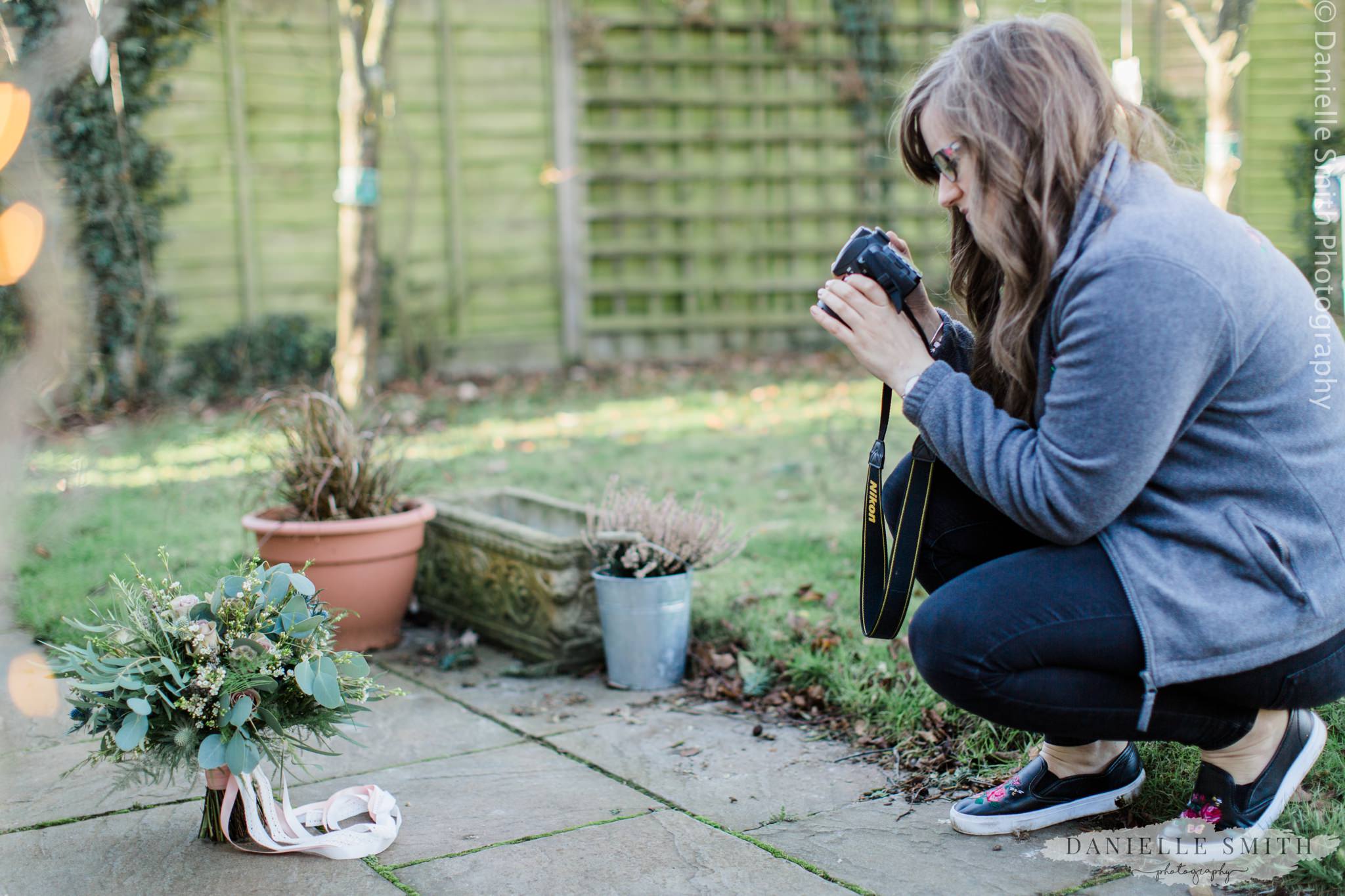 lady taking photos of wedding bouquet