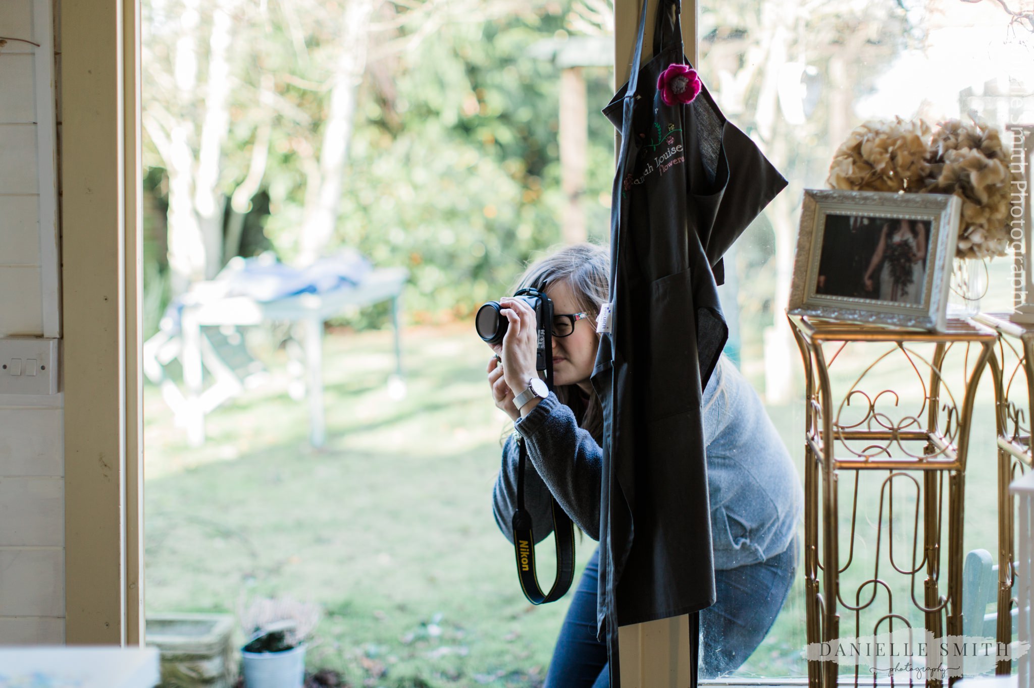 florist taking photos in her workshop