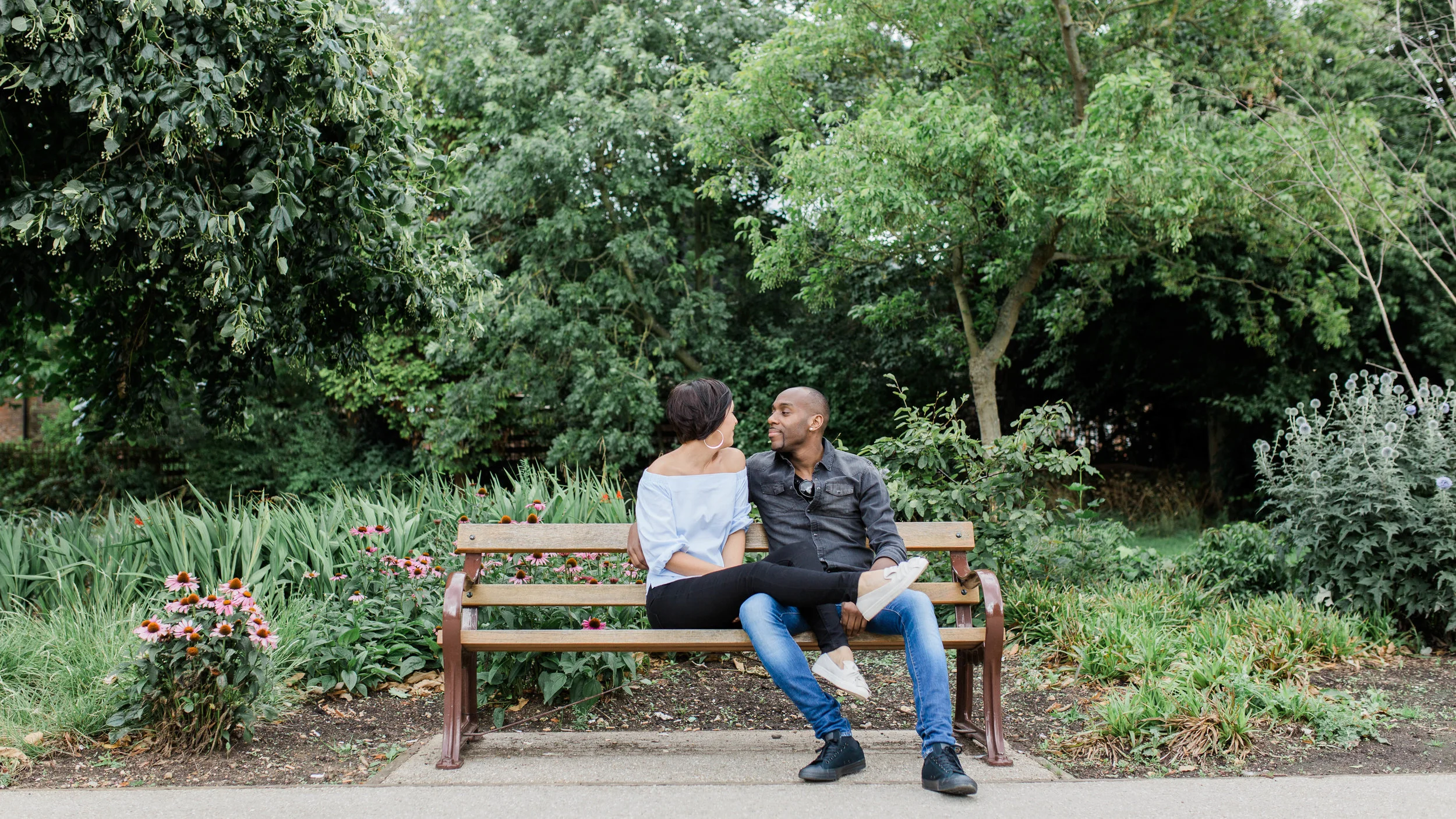 couple sitting on bench in park - engagement photography