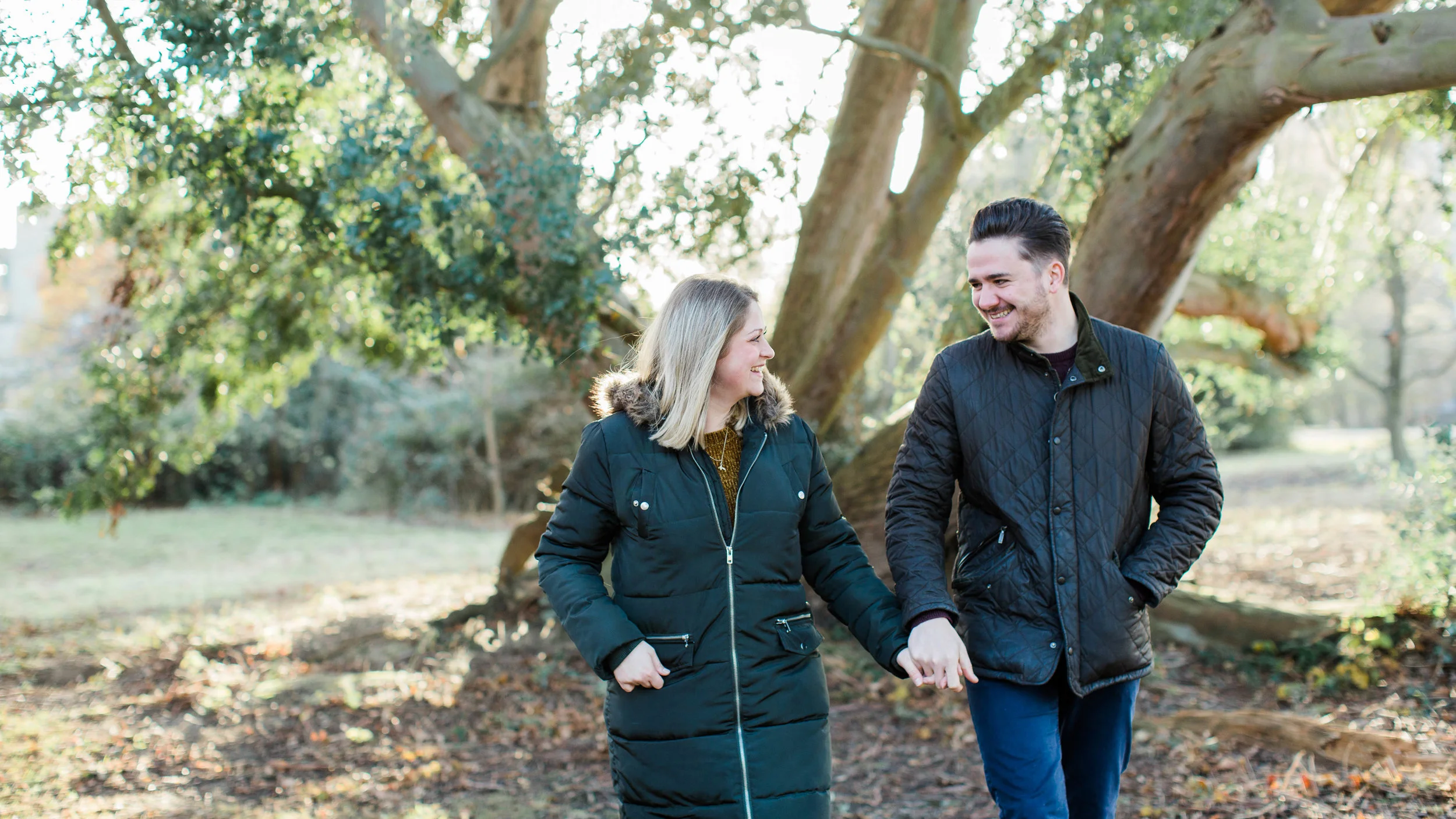 autumn pre wedding photo of couple walking
