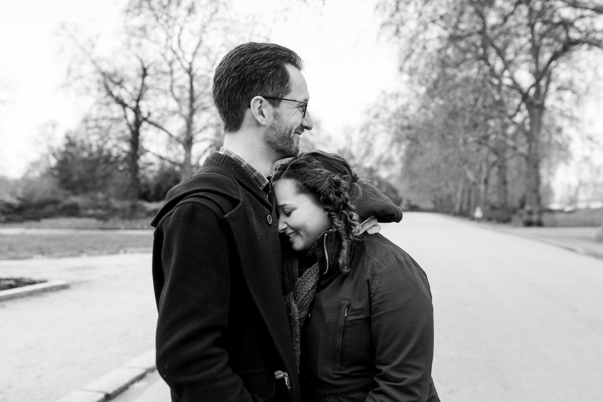 couple snuggling in pre-wedding photography battersea park