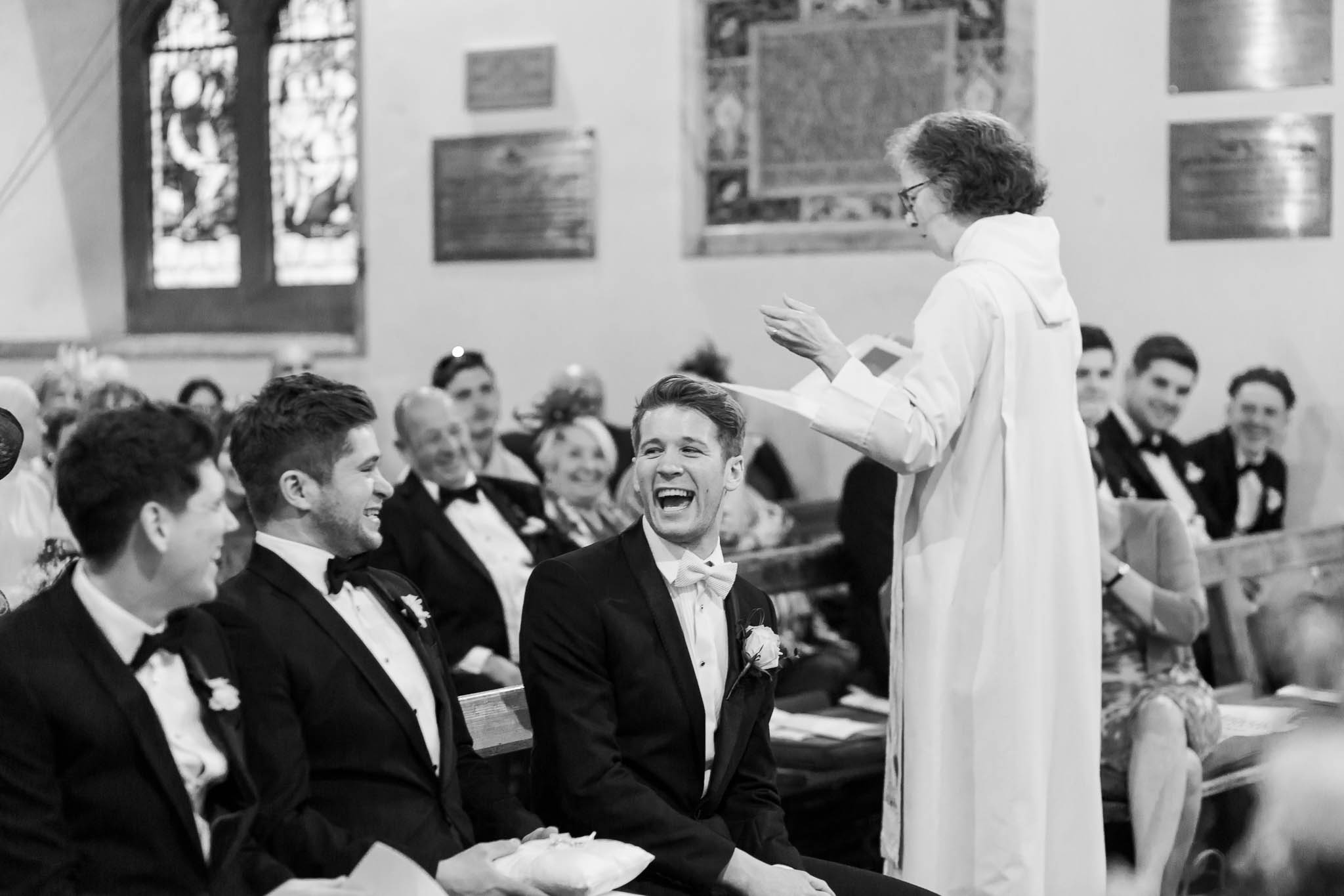 groom laughing with best men in church