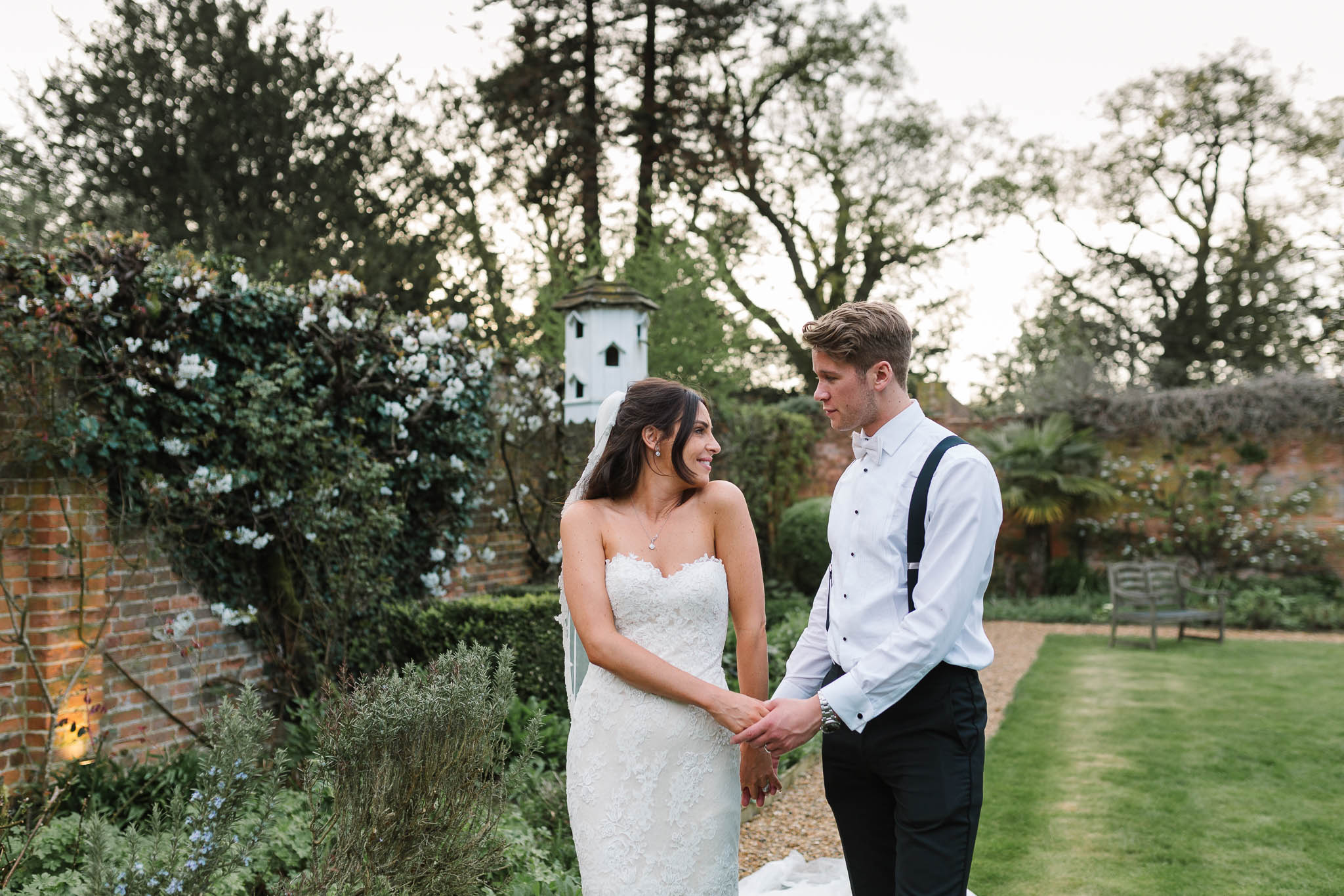 bride and groom walking together in gardens