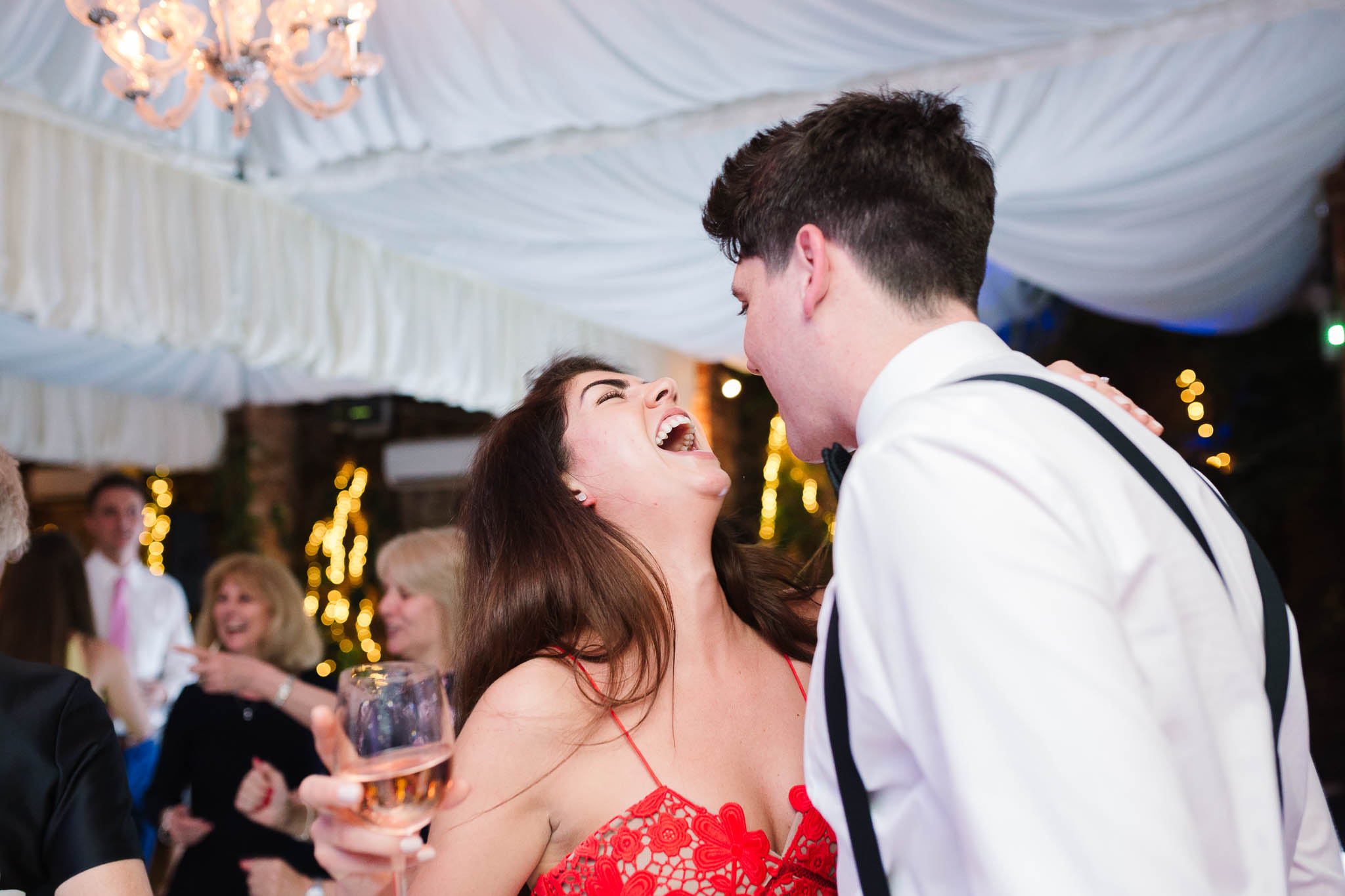wedding guests dancing and laughing