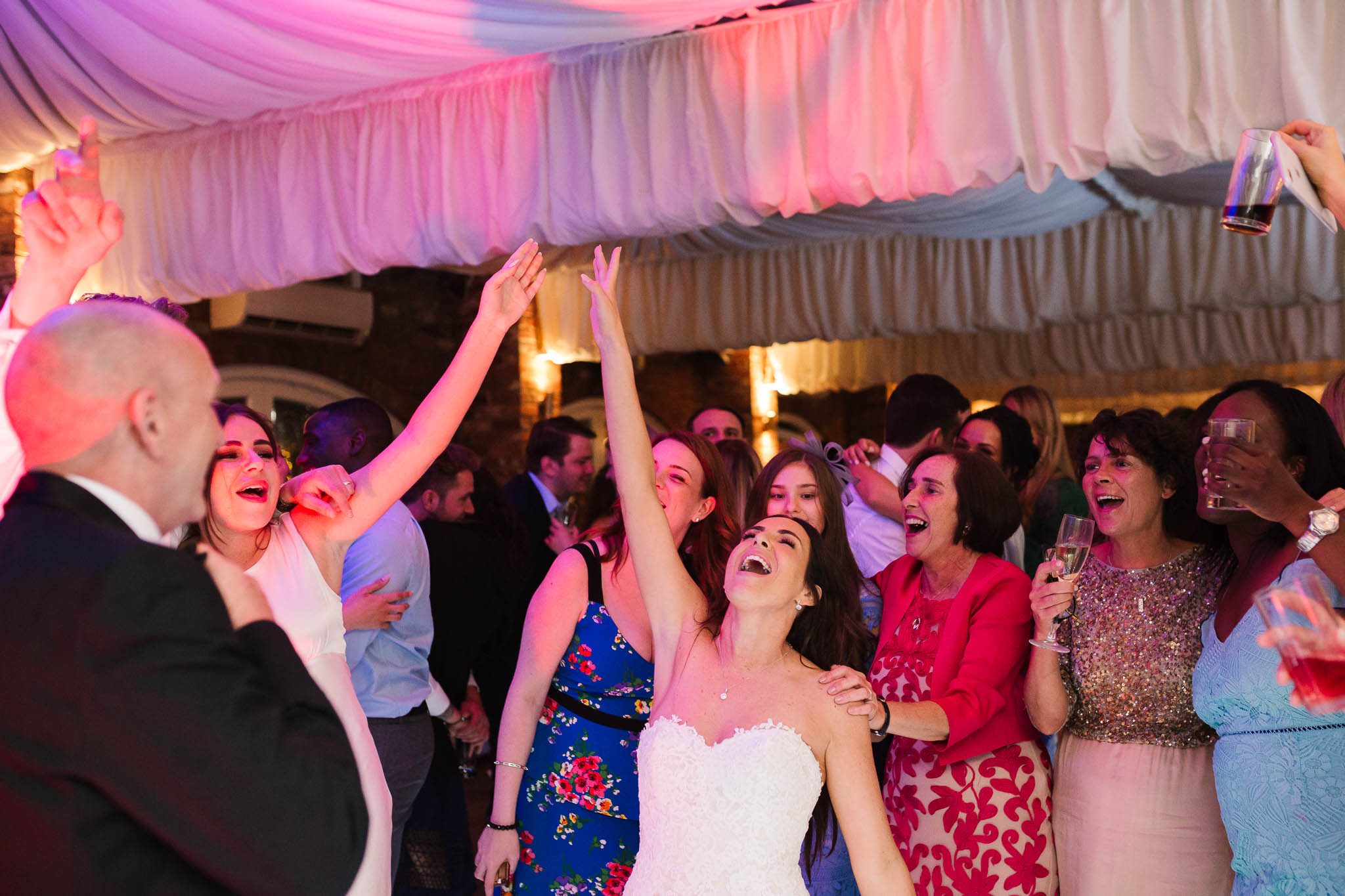 bride dancing with her dad and friends
