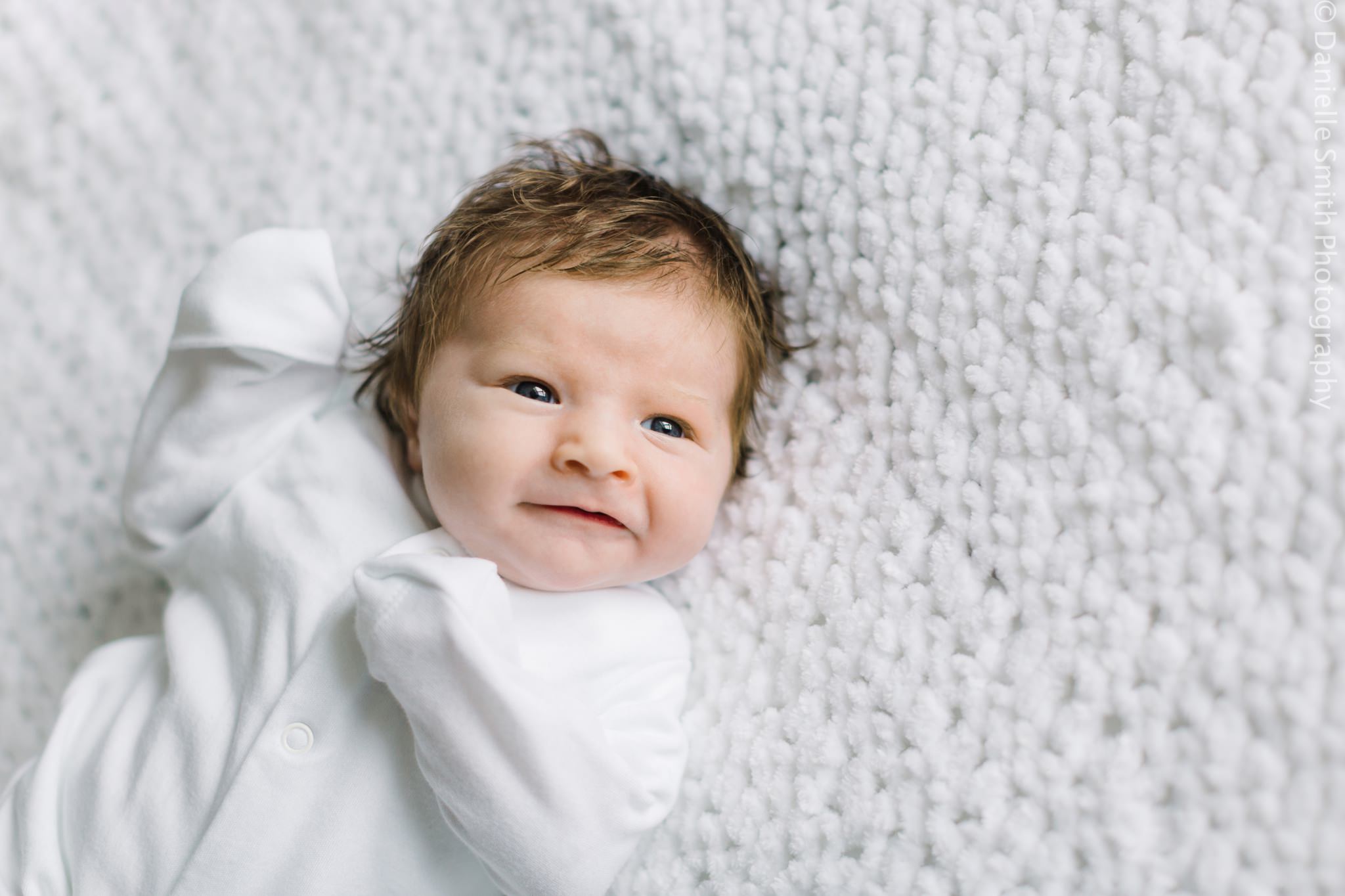 newborn baby smiling