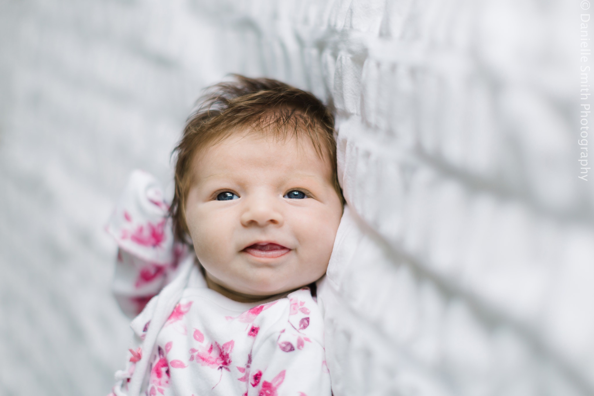 newborn baby in pink floral romper
