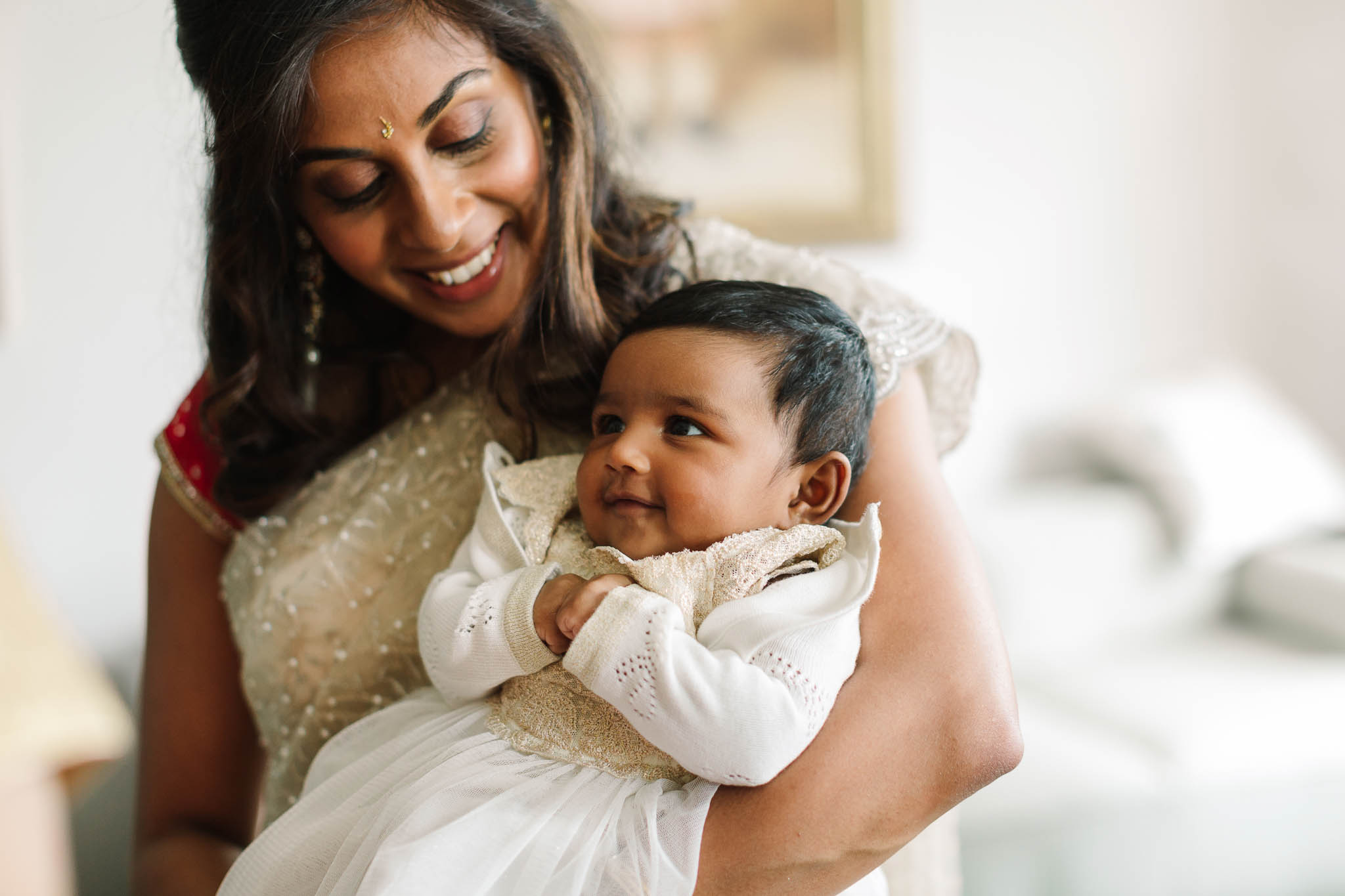 mum holding her baby girl at wedding