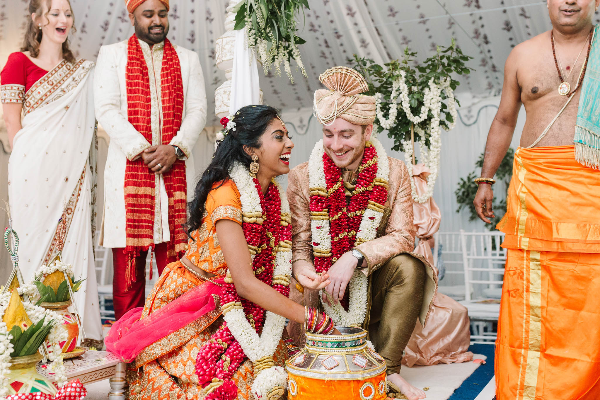 bride and groom hunting for ring in pot