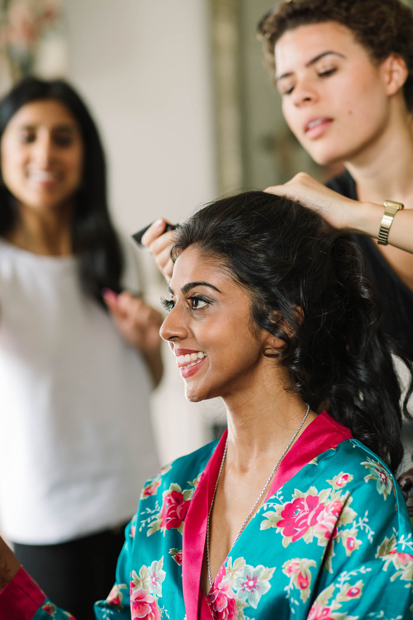bride getting hair done at wedding