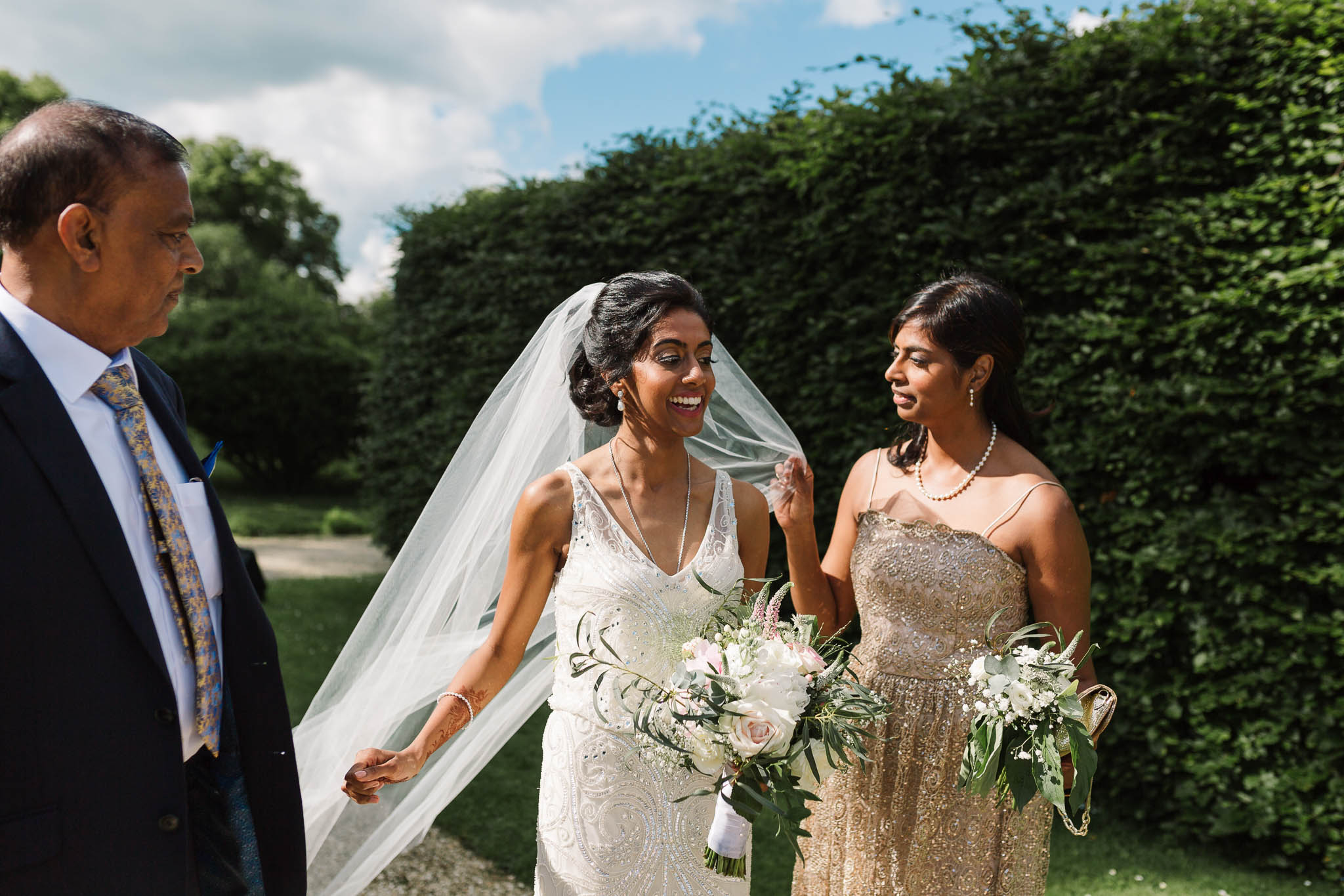 bride and her sister fixing veil