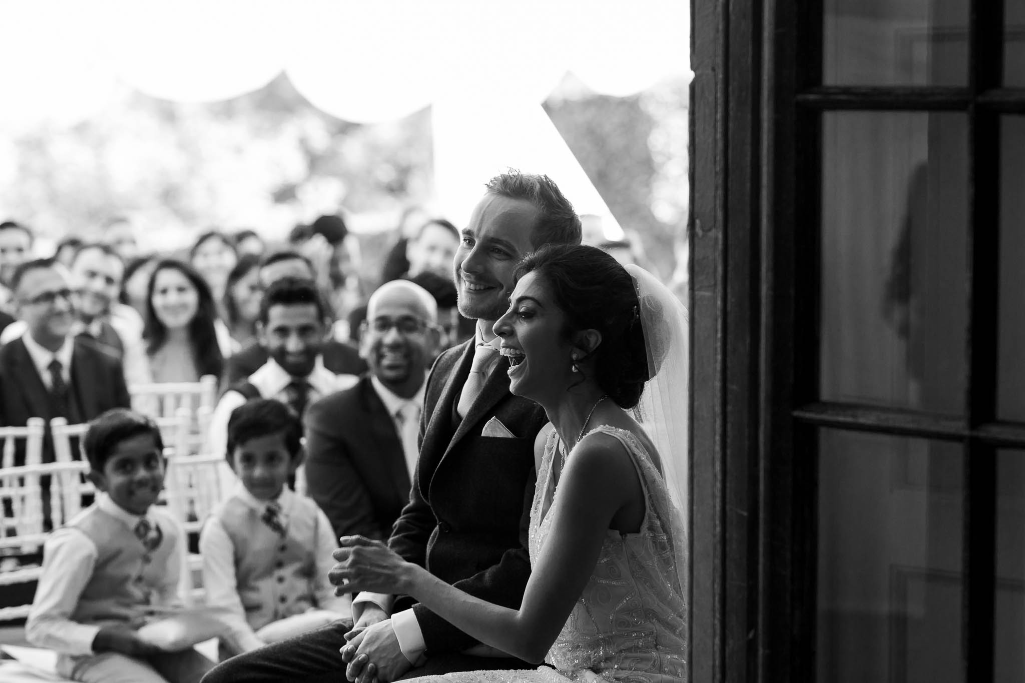 bride and groom laughing during ceremony