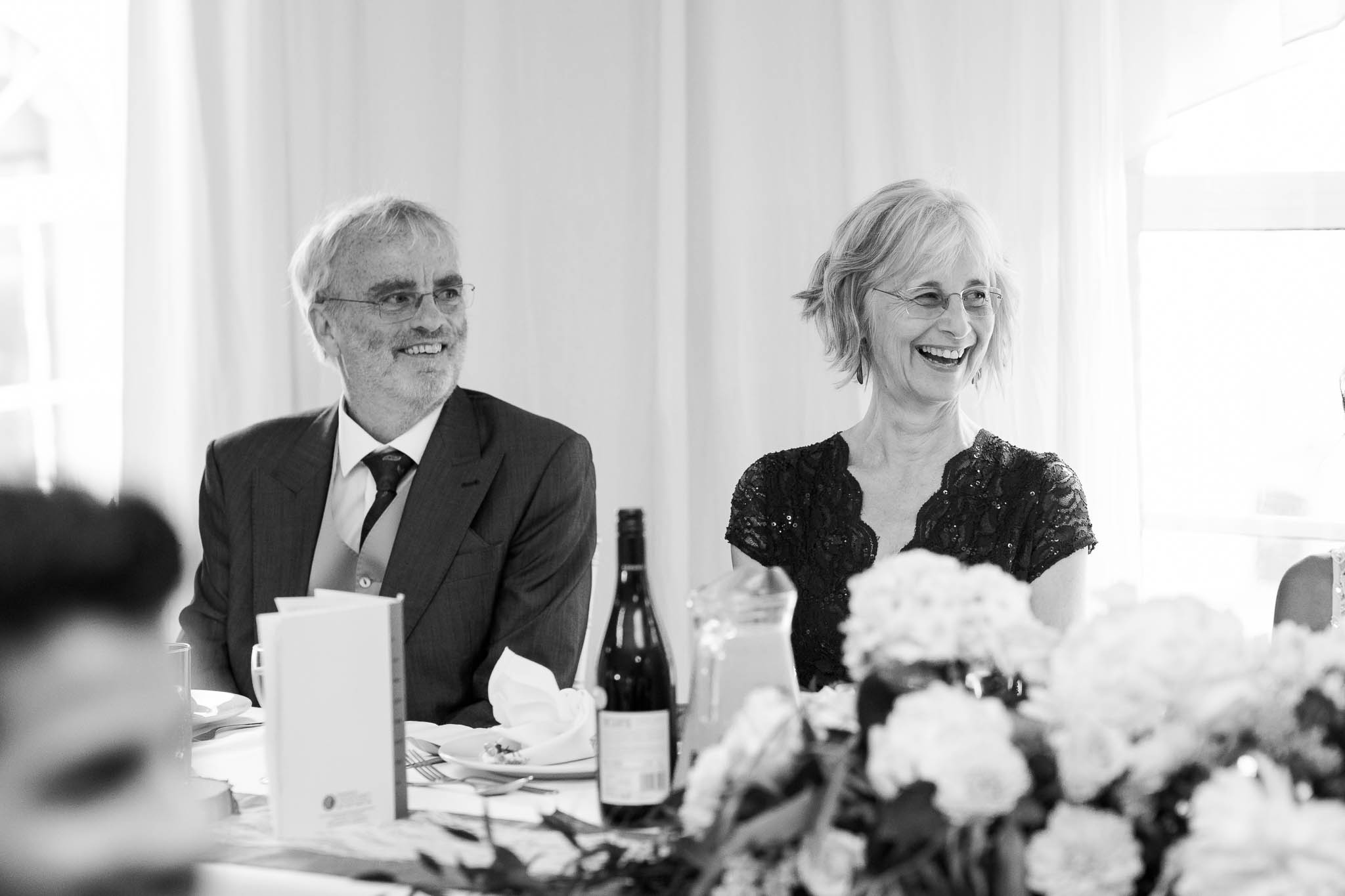 parents laughing at wedding speeches
