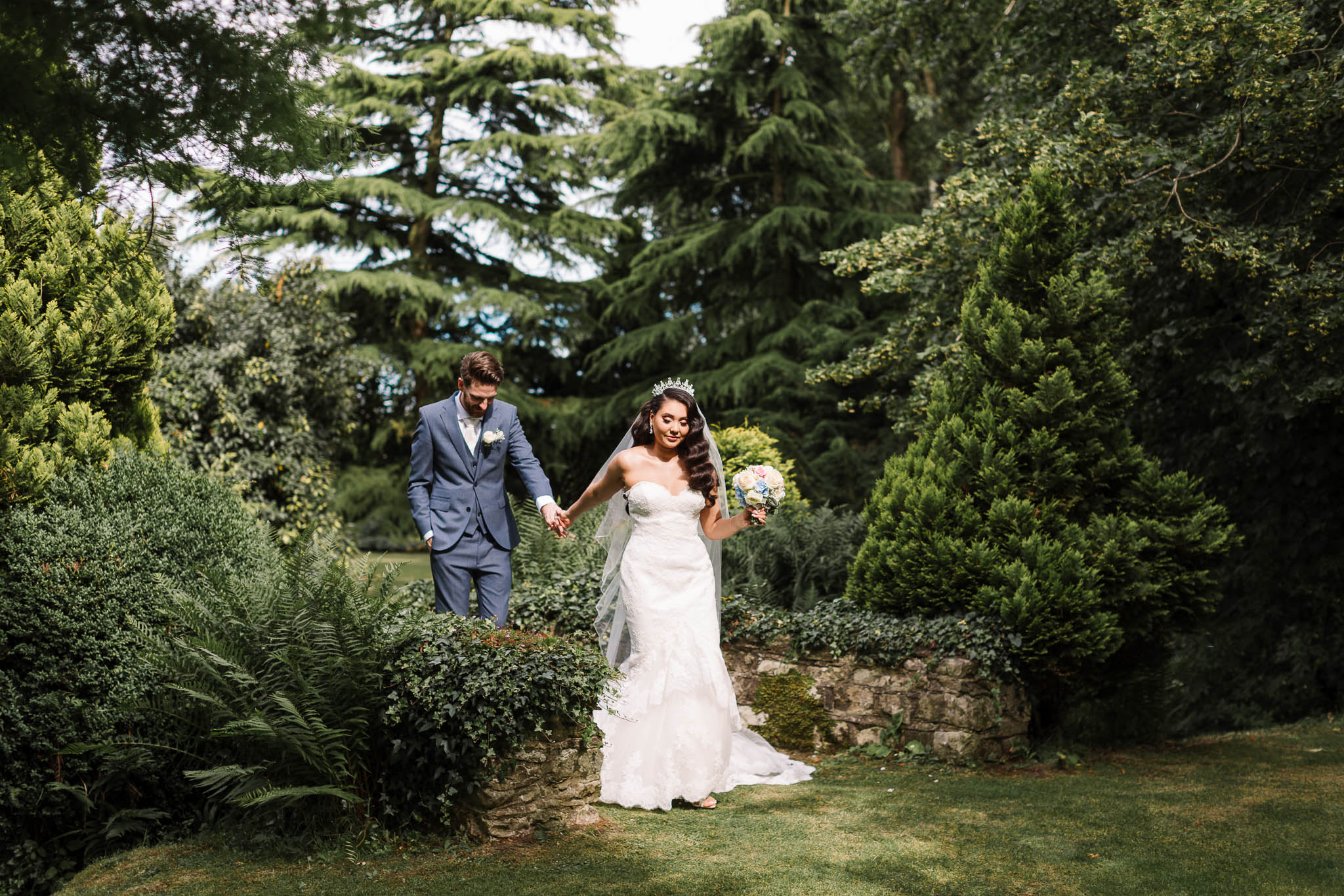 bride and groom walking through gardens at brewerstreet farmhouse wedding