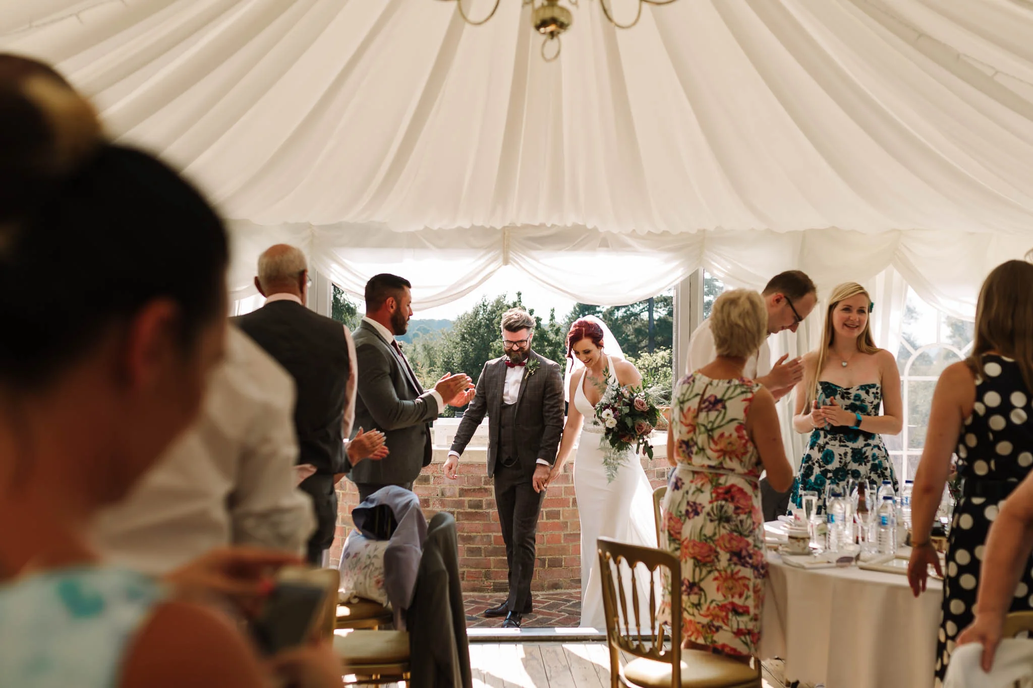bride and groom entering marquee