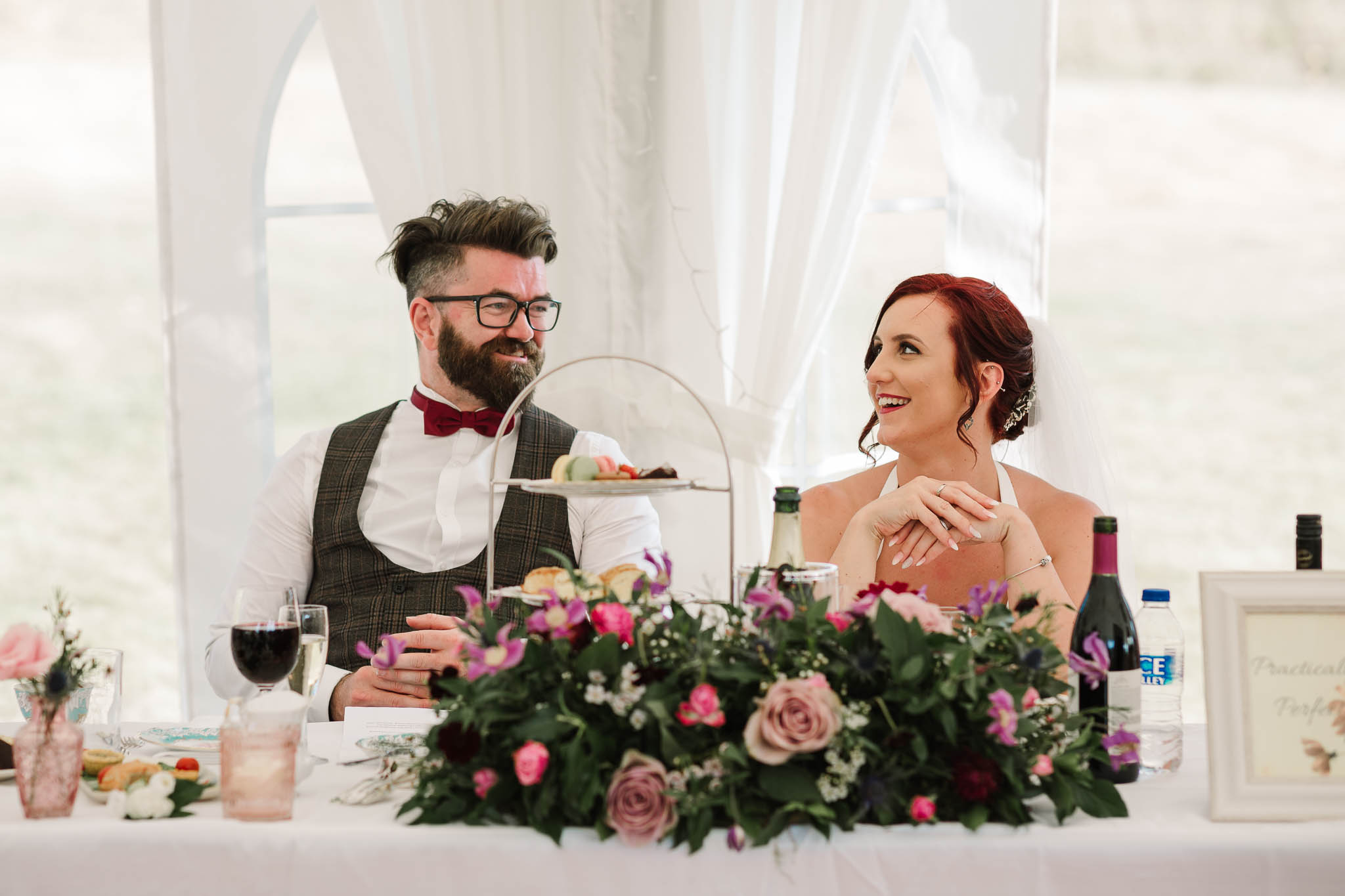 bride and groom laughing at speeches