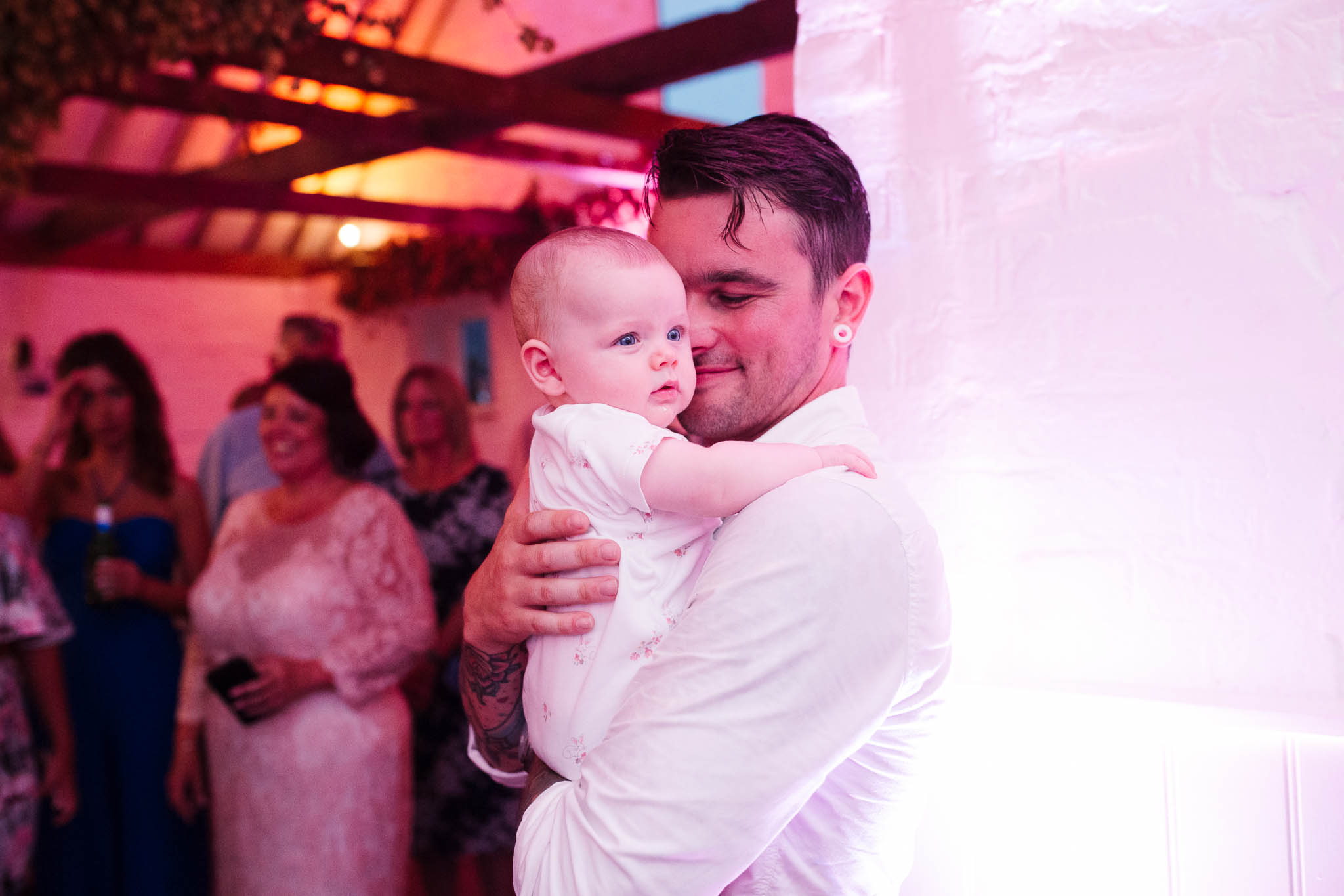dad dancing with baby at wedding