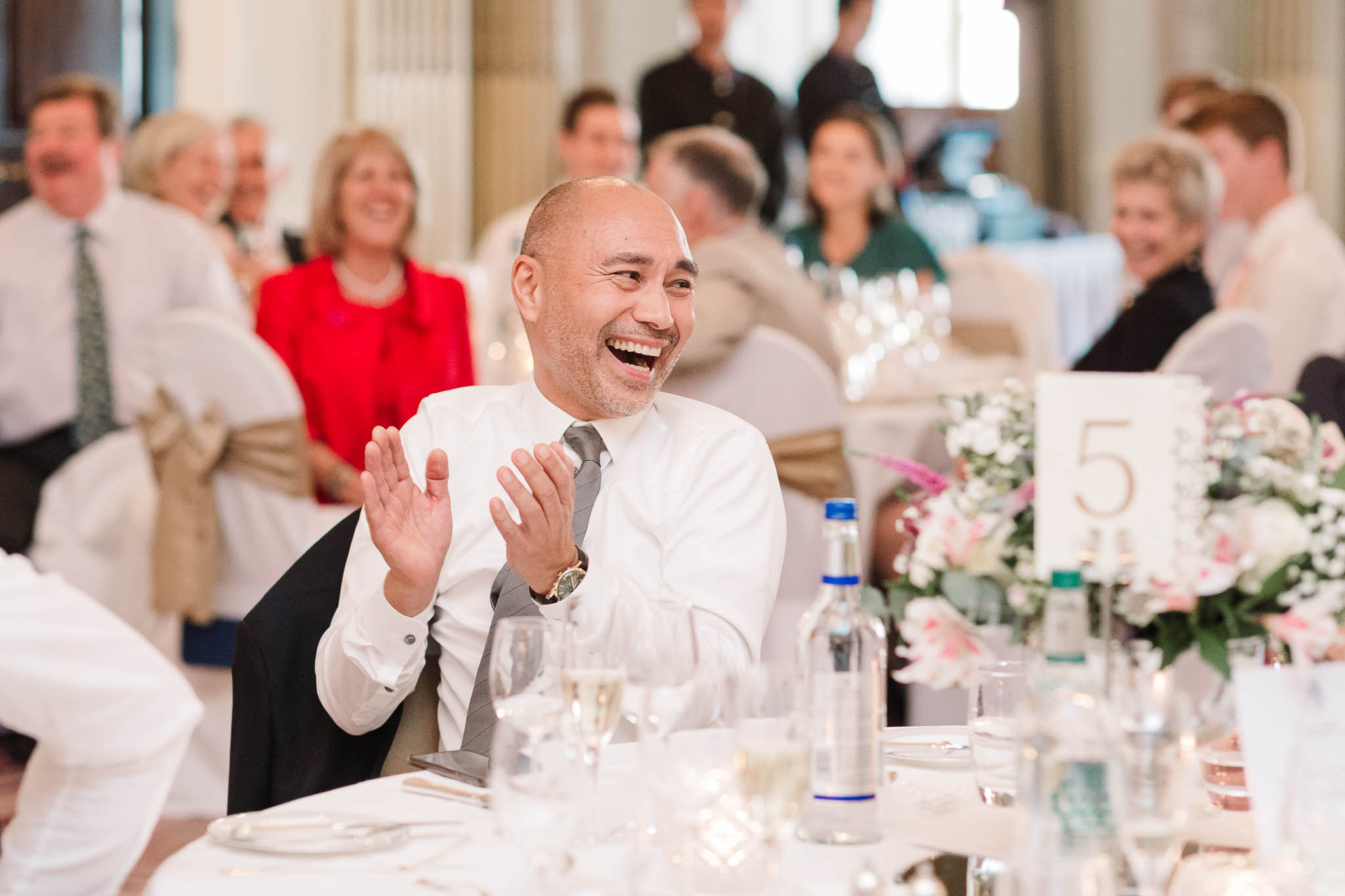 wedding guest laughing at speeches
