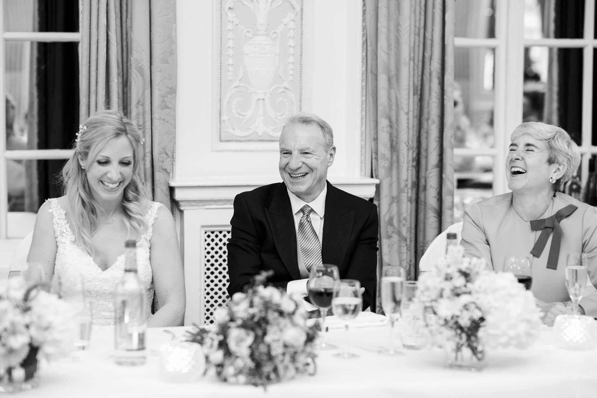 bride and parents laughing