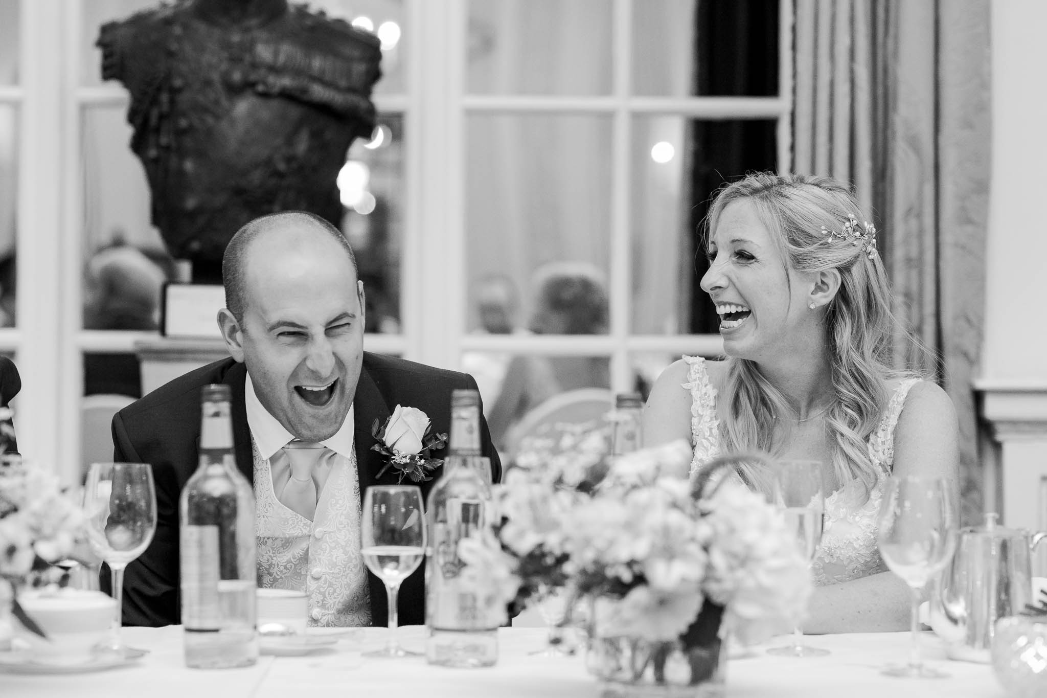 bride and groom laughing at speeches