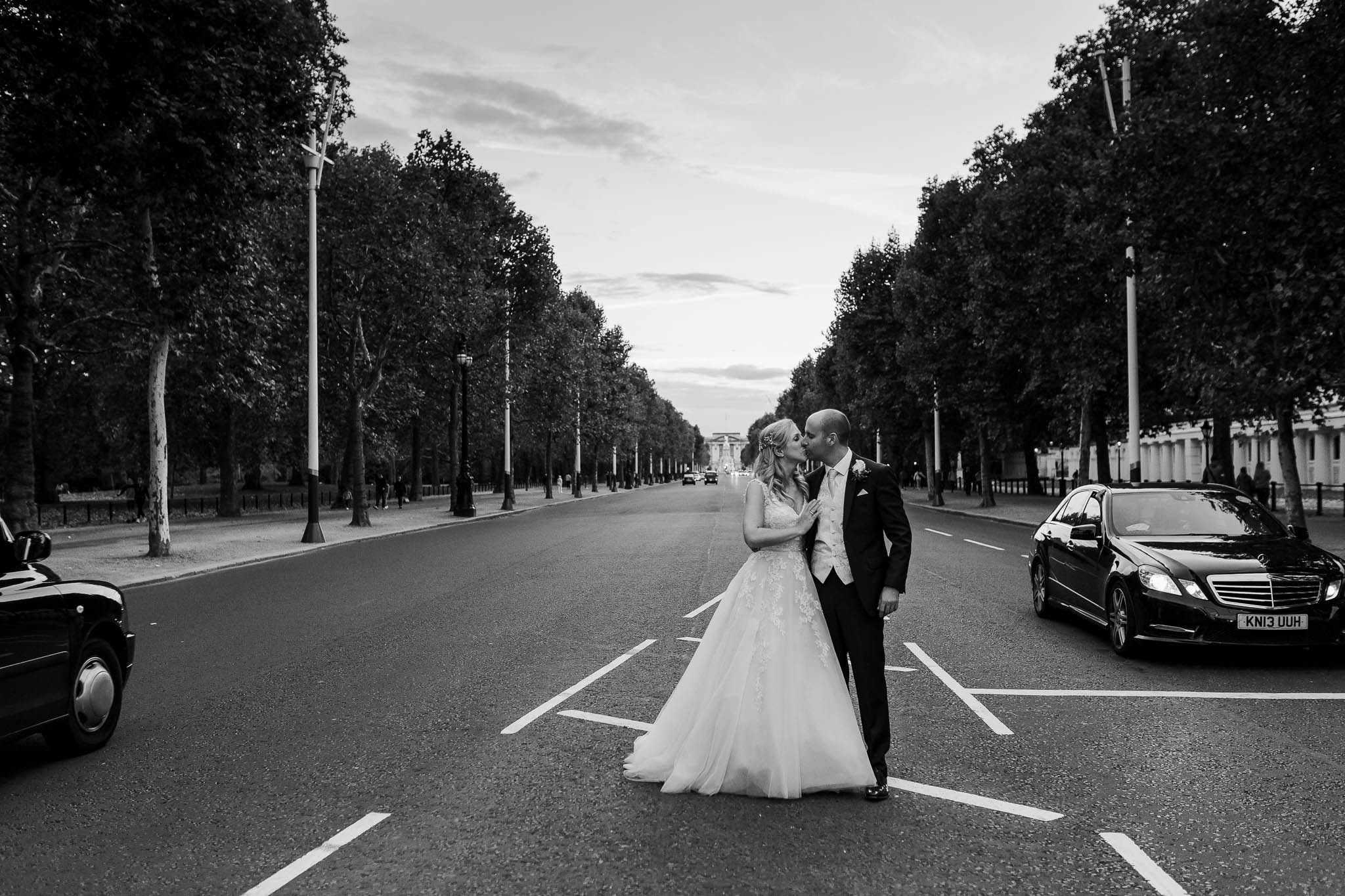 bride and groom in front go buckingham palace - Elegant London Wedding at the Royal Automobile Club