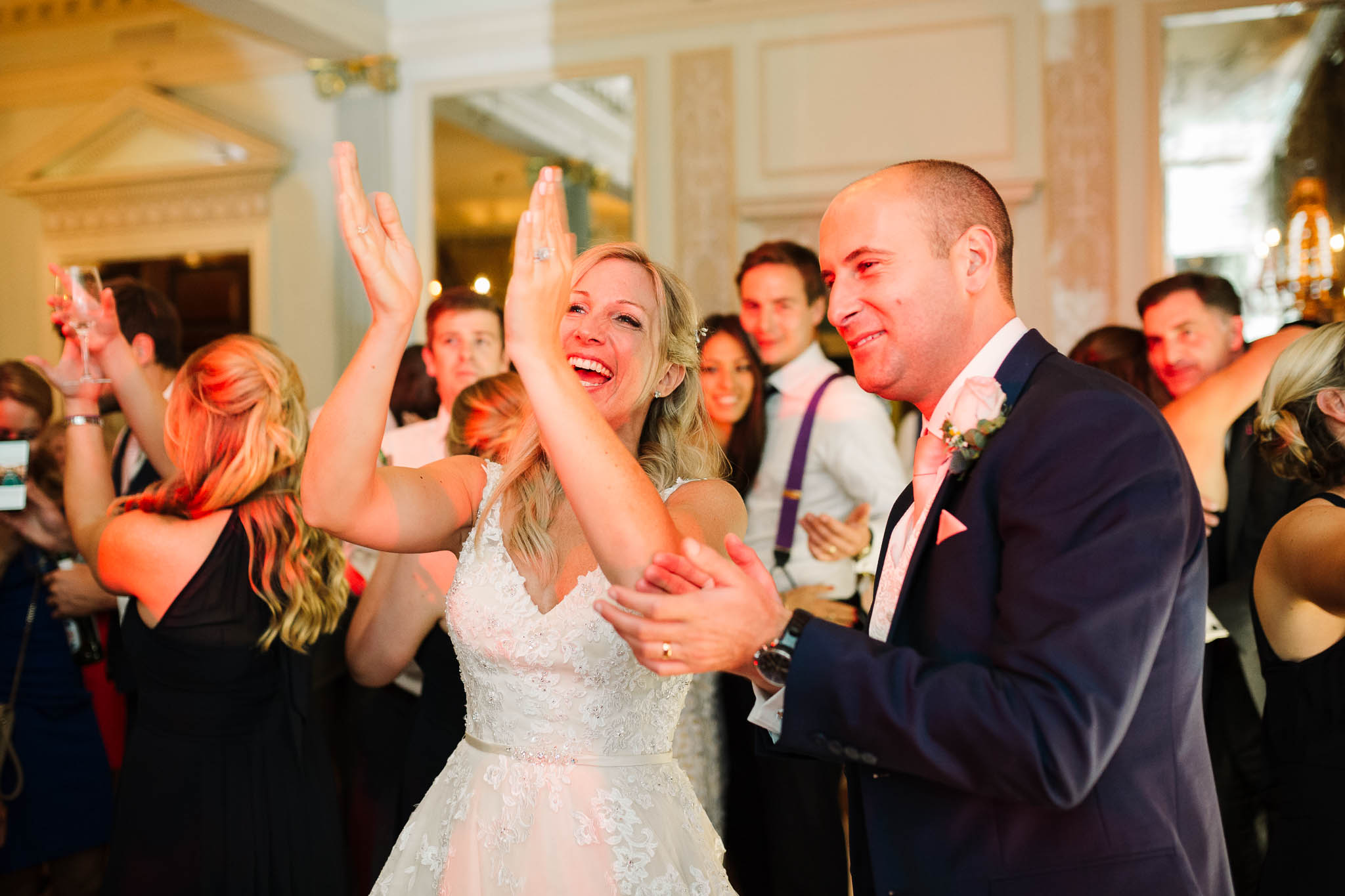 bride and groom clapping at first dance