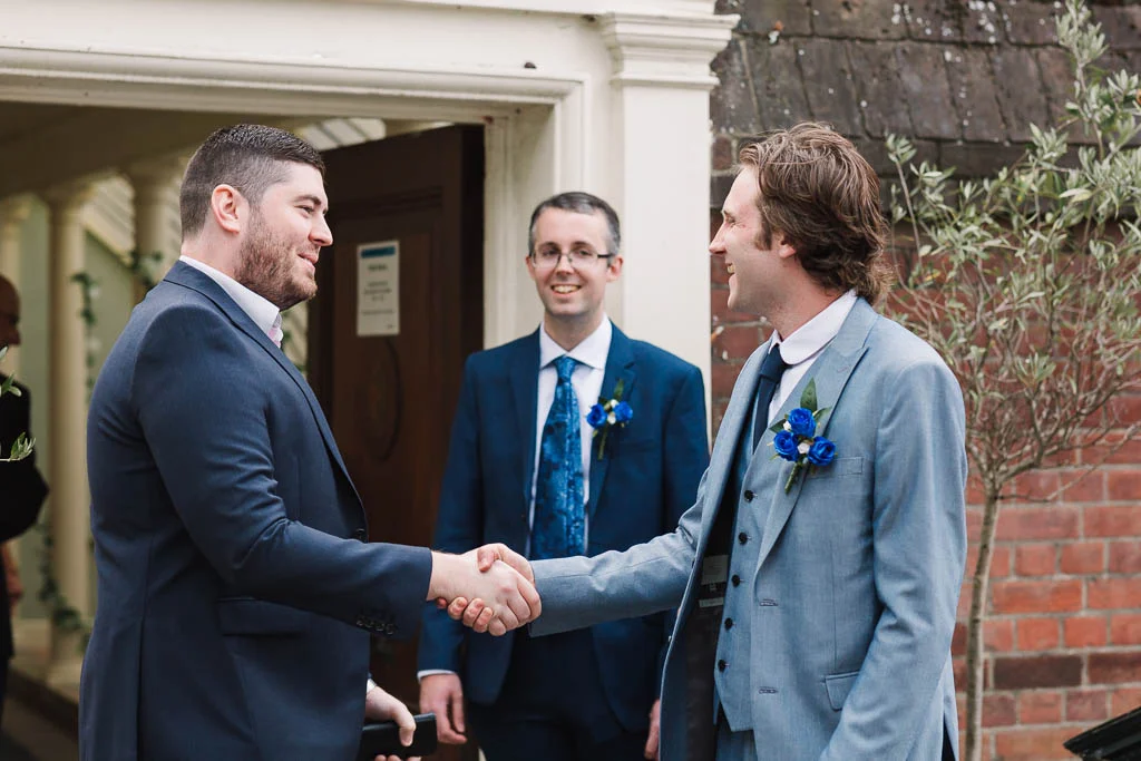 groom greeting guests at wedding