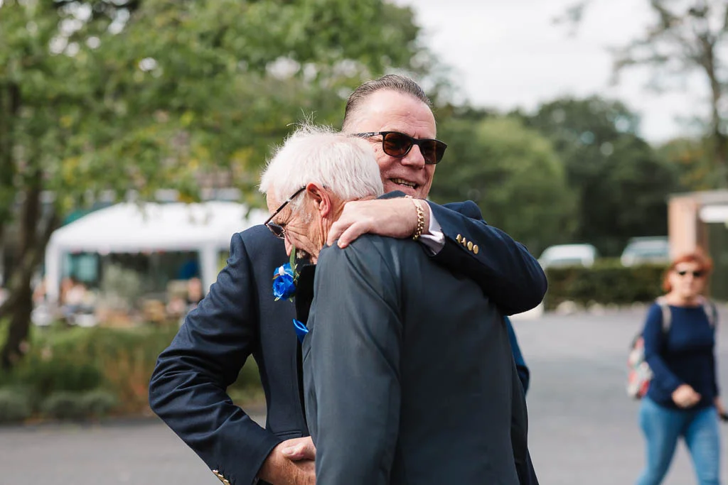 wedding guests hugging