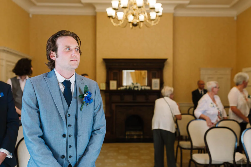 groom waiting for the bride to enter - LANGTONS HOUSE WEDDING