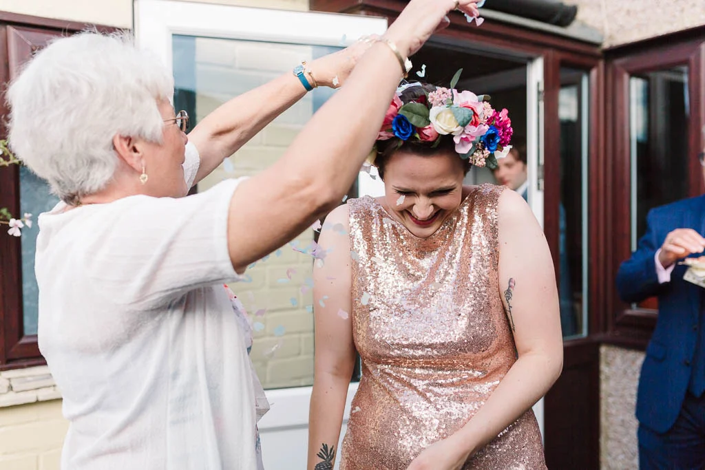 auntie throwing confetti over bride