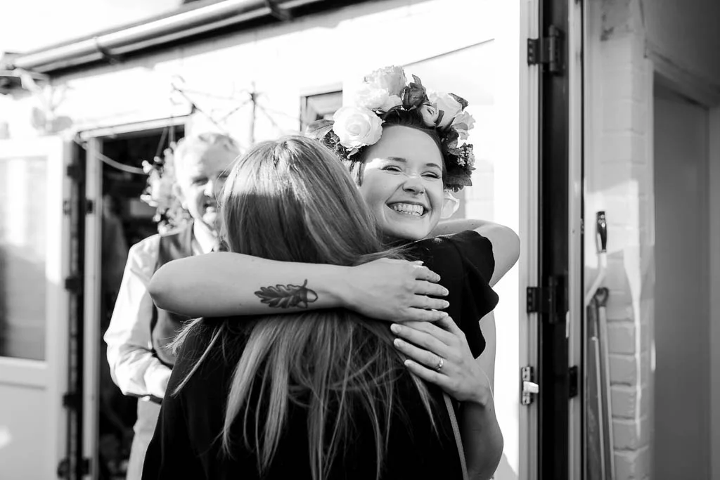 bride hugging wedding guest