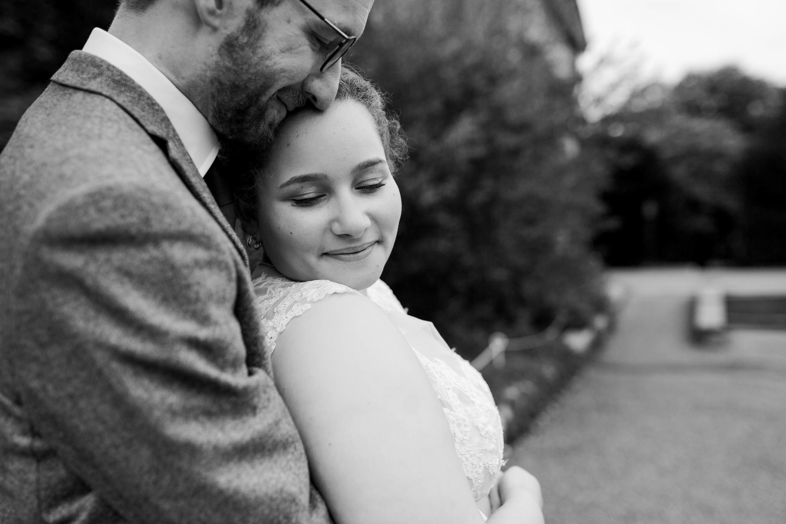 close up of bride and groom hugging