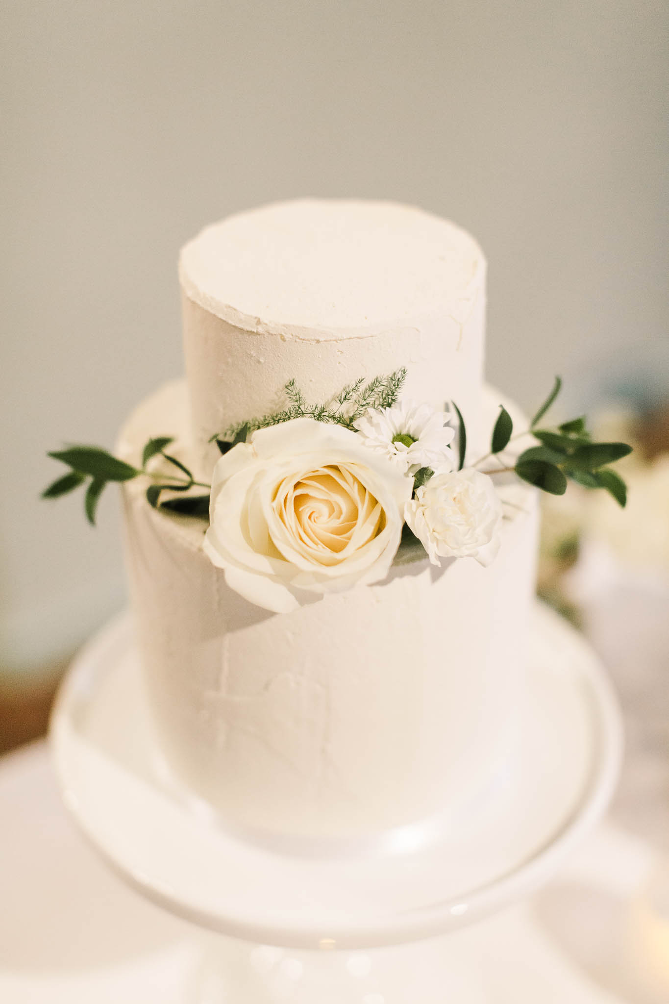 white wedding cake with ivory rose