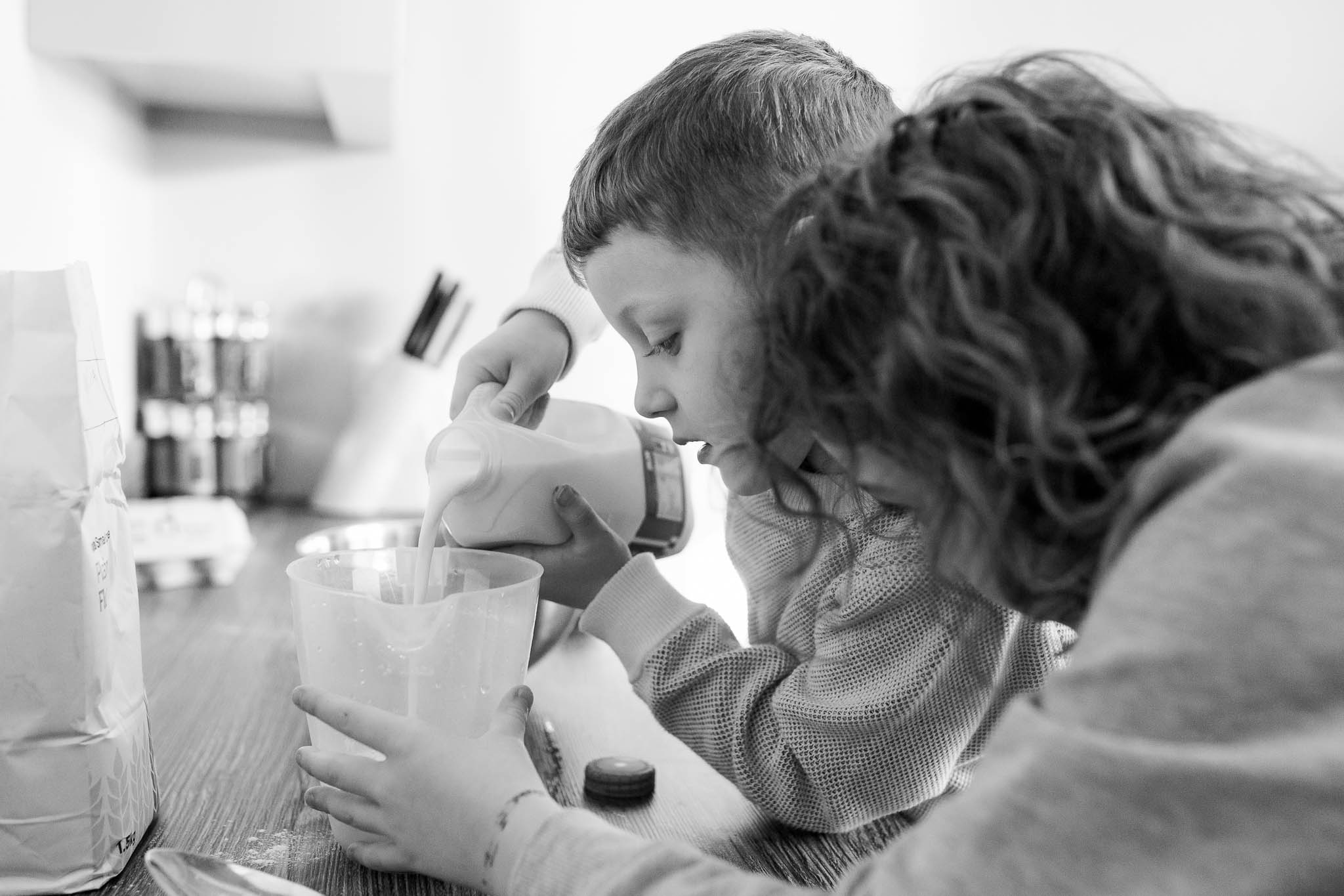 adding the milk to pancakes